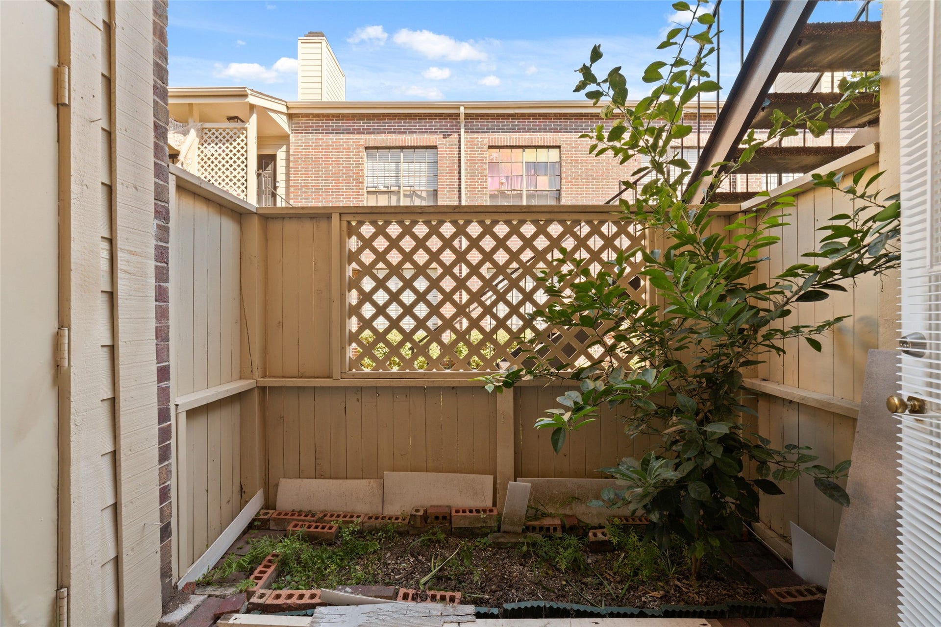 Side patio for fresh air or plant your own garden.