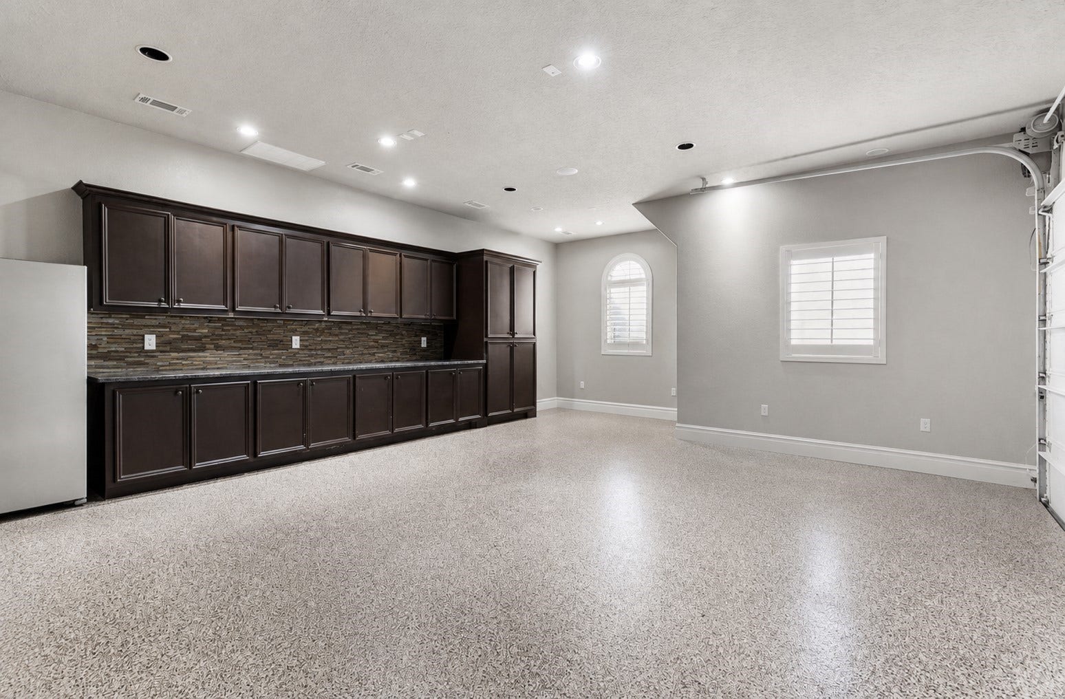 7930 Spring Village Drive, Spring, TX 77389 Garage has custom cabinets and epoxy flooring.