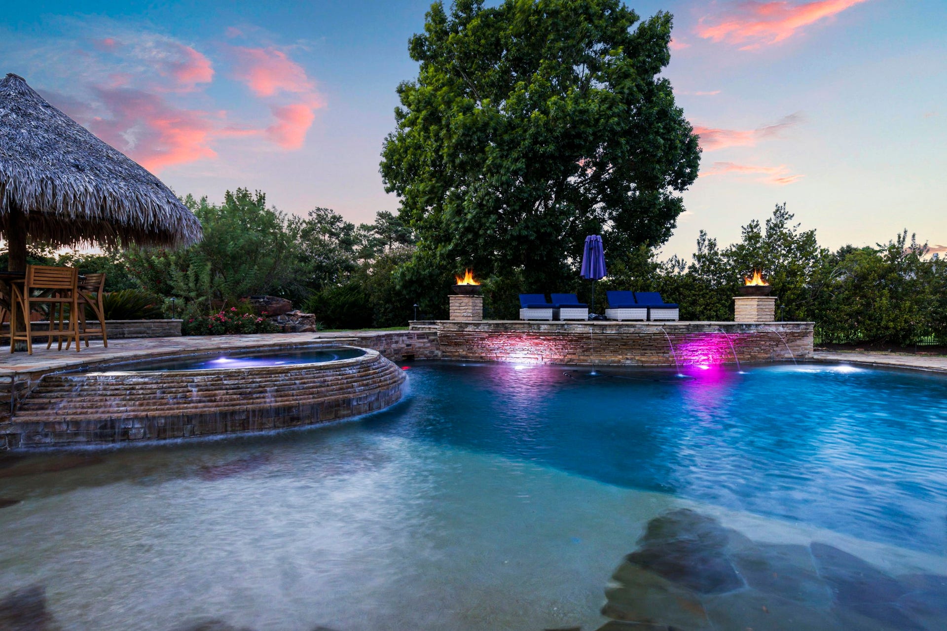 7930 Spring Village Drive, Spring, TX 77389 Lighted pool with fire bowls.