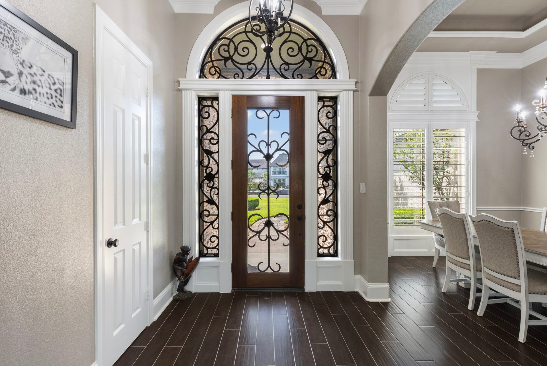 7930 Spring Village Drive, Spring, TX 77389 Inviting door with custom front door and wrought iron hardware.