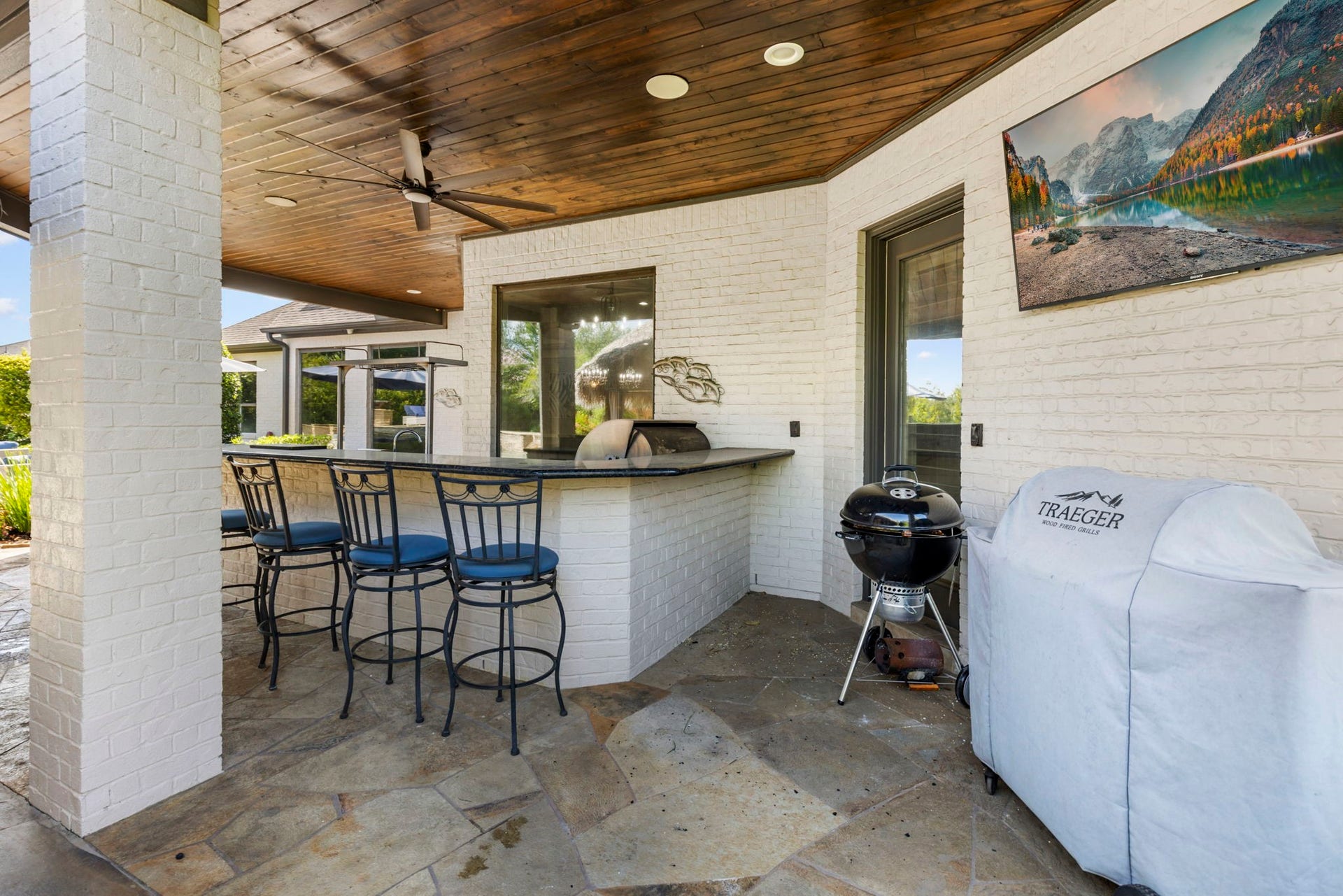 7930 Spring Village Drive, Spring, TX 77389 Bar area and TV next to to outdoor kitchen.