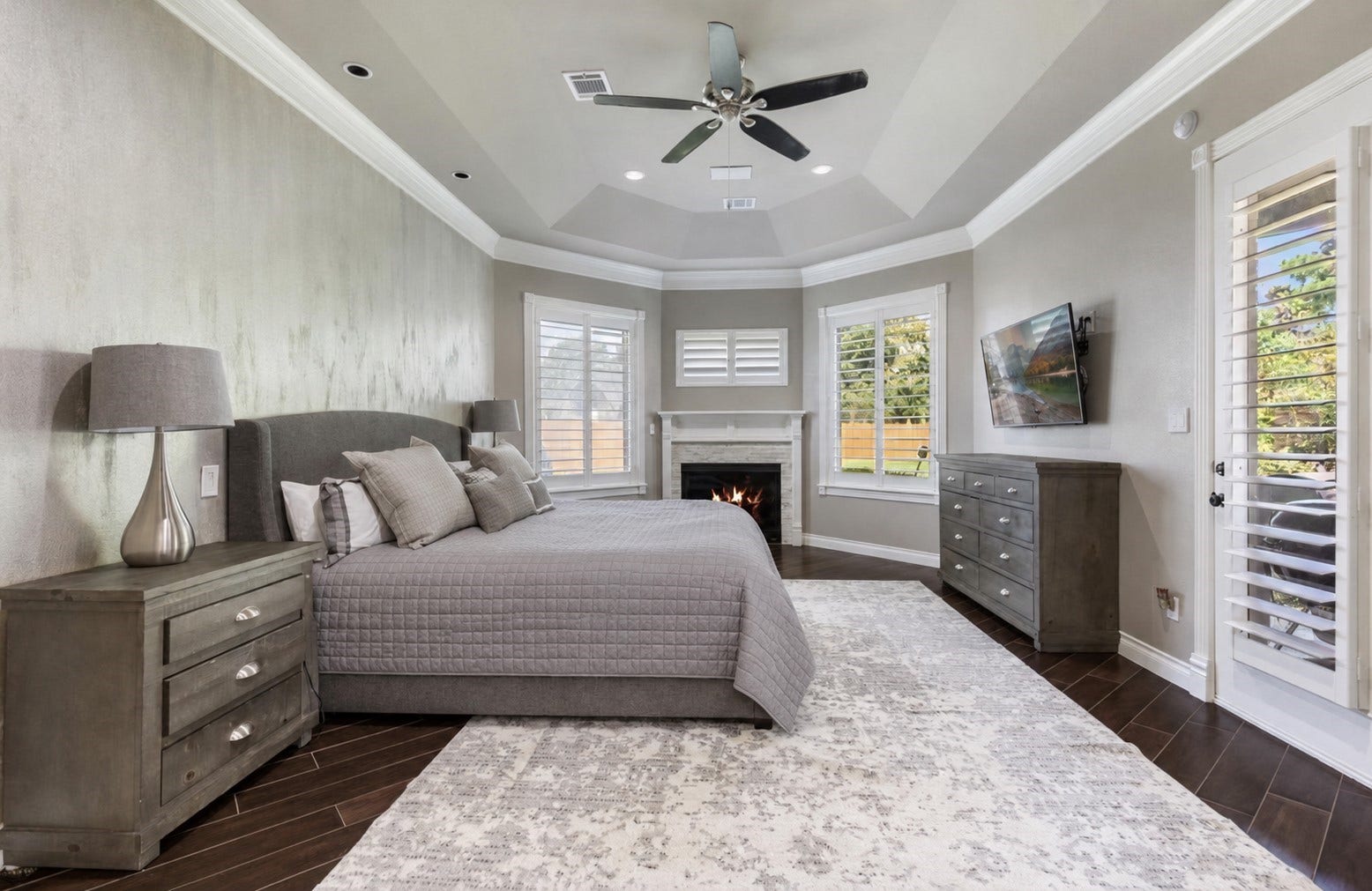 7930 Spring Village Drive, Spring, TX 77389 Primary suite has a cozy fireplace and door leading out to outdoor patio.