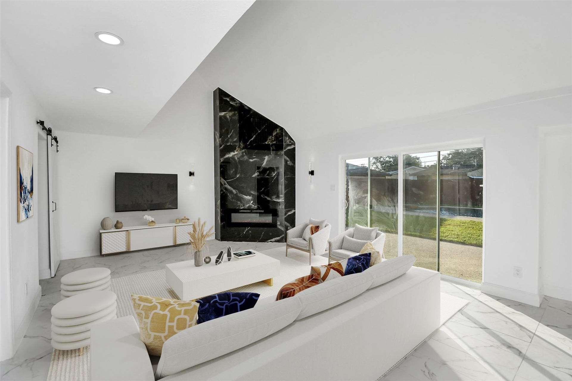 6035 Cartagena Street, Houston, TX 77035 A modern den features soaring vaulted ceilings and a striking black marble accent wall, complemented by a mounted modern fireplace, making a bold and sophisticated statement. (Virtually Staged)