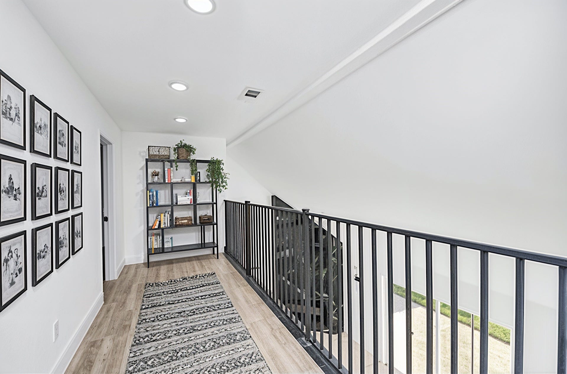 6035 Cartagena Street, Houston, TX 77035 The upstairs features engineered wood floors that are both low-maintenance and durable, adding a warm touch. (Virtually Staged)