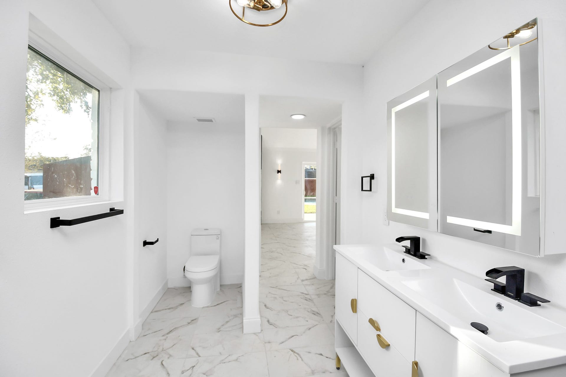 6035 Cartagena Street, Houston, TX 77035 Dual sinks and black hardware round out this bathroom.