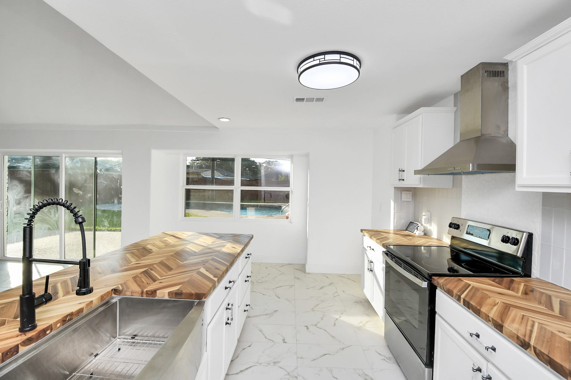 6035 Cartagena Street, Houston, TX 77035 The herringbone butcher block countertops stand out in this kitchen, creating a striking and eye-catching focal point.