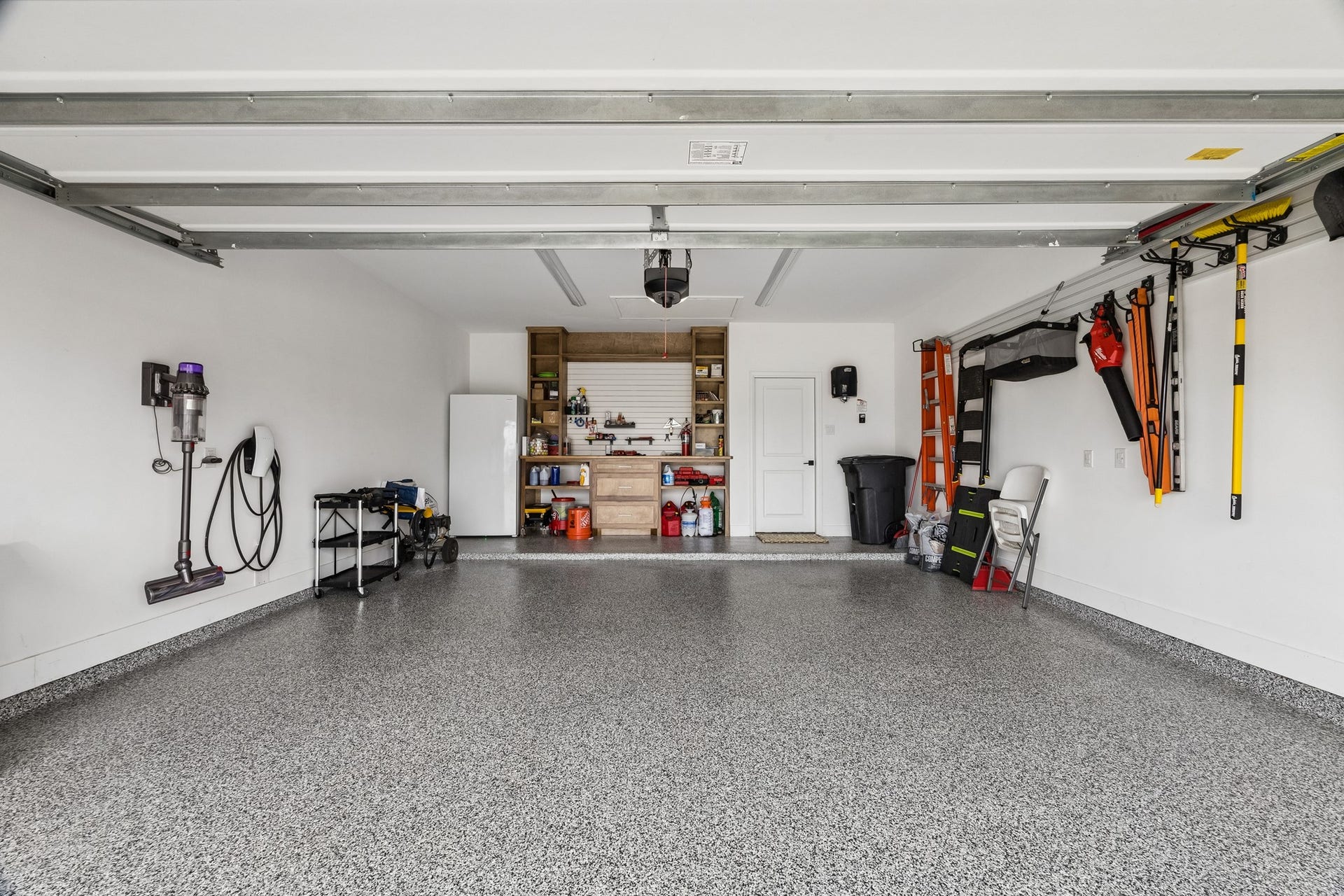 2118 Cottage Bridge Road, League City, TX 77573 The ulimate garage upgrade features epoxy-coated floors, a solid wood workbench, slat-wall storage orgainzation, and ample space for projects, hobbies and vehicles.