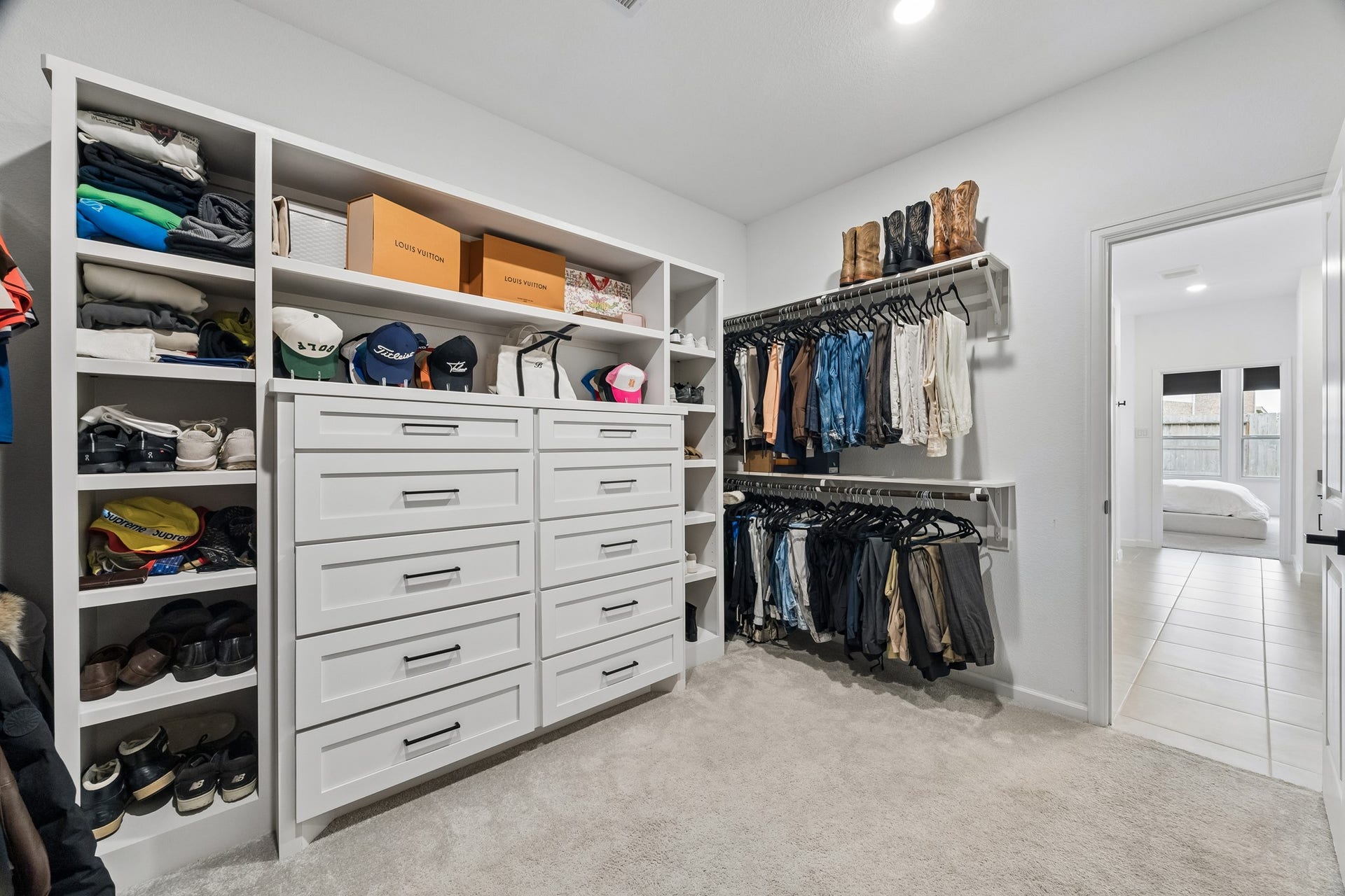2118 Cottage Bridge Road, League City, TX 77573 The primary closet had built-in shelves and cabinets added for ample organizaion and storage. There was also shelves added above each hanging rack.