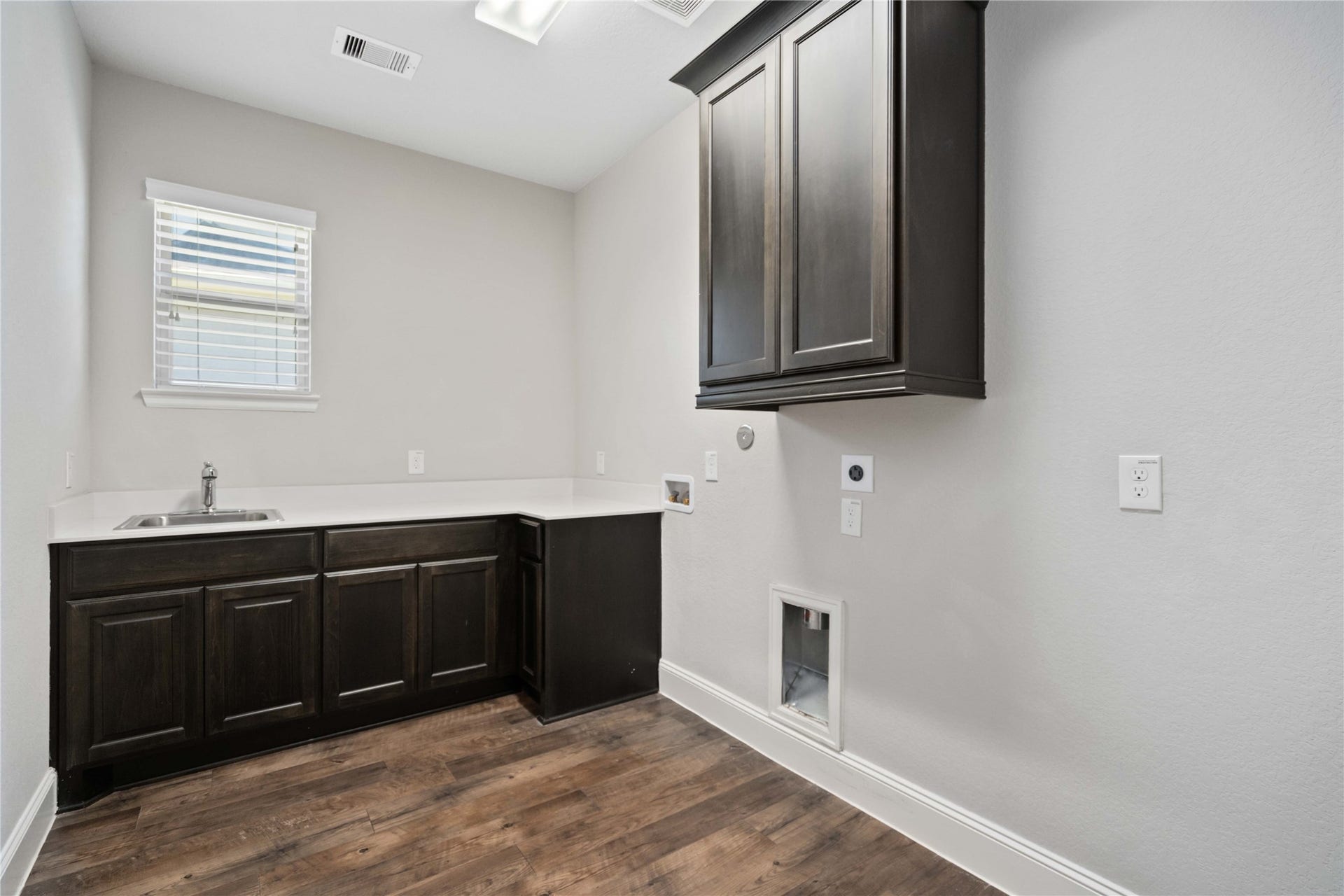 2710 Big Vine Court, Missouri City, TX 77459 Utility room with sink and built-in cabinets!