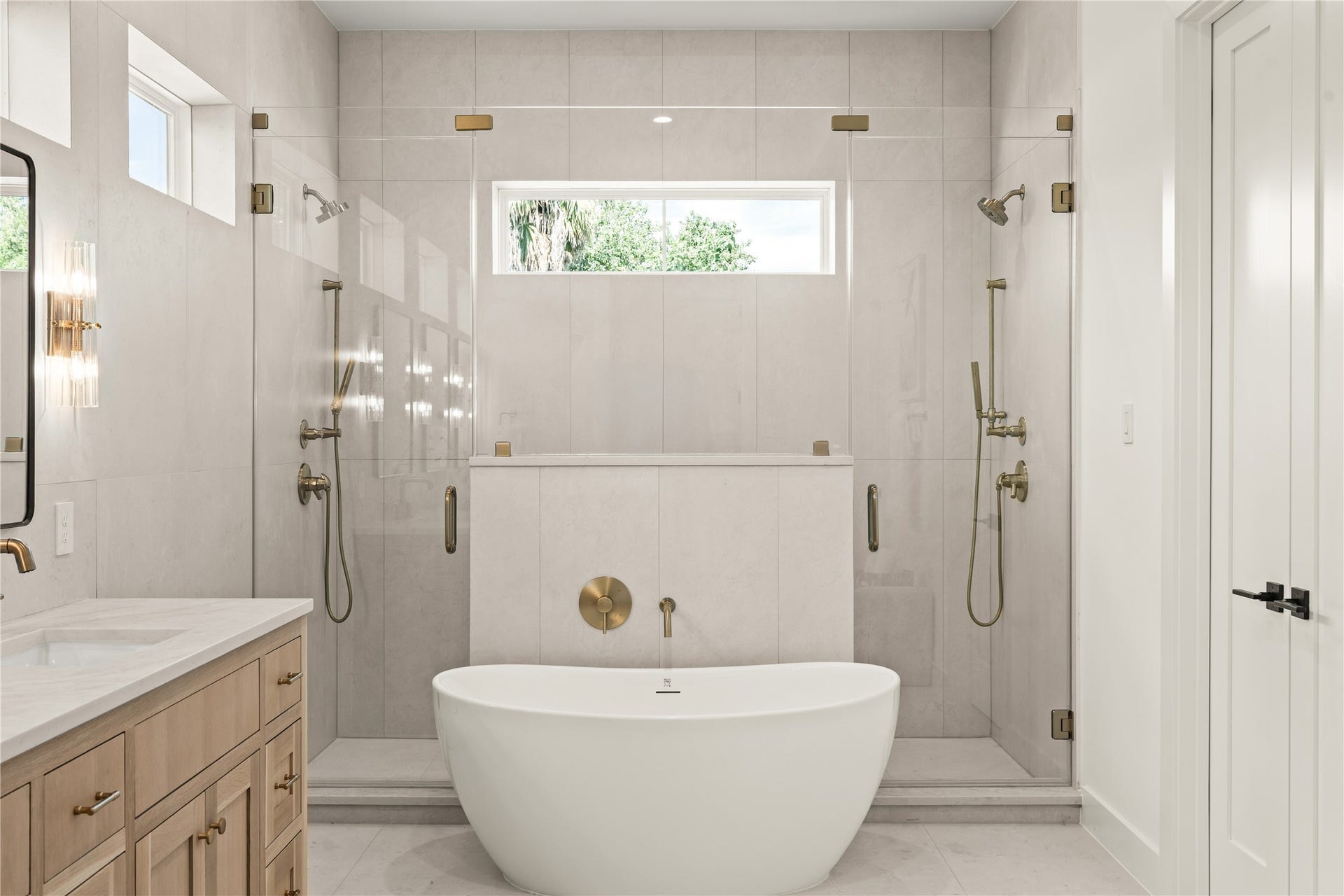 2011 Singleton Street, Houston, TX 77008 Primary bathroom with dual Delta Trinsic champagne bronze shower heads/wands and soaking tub