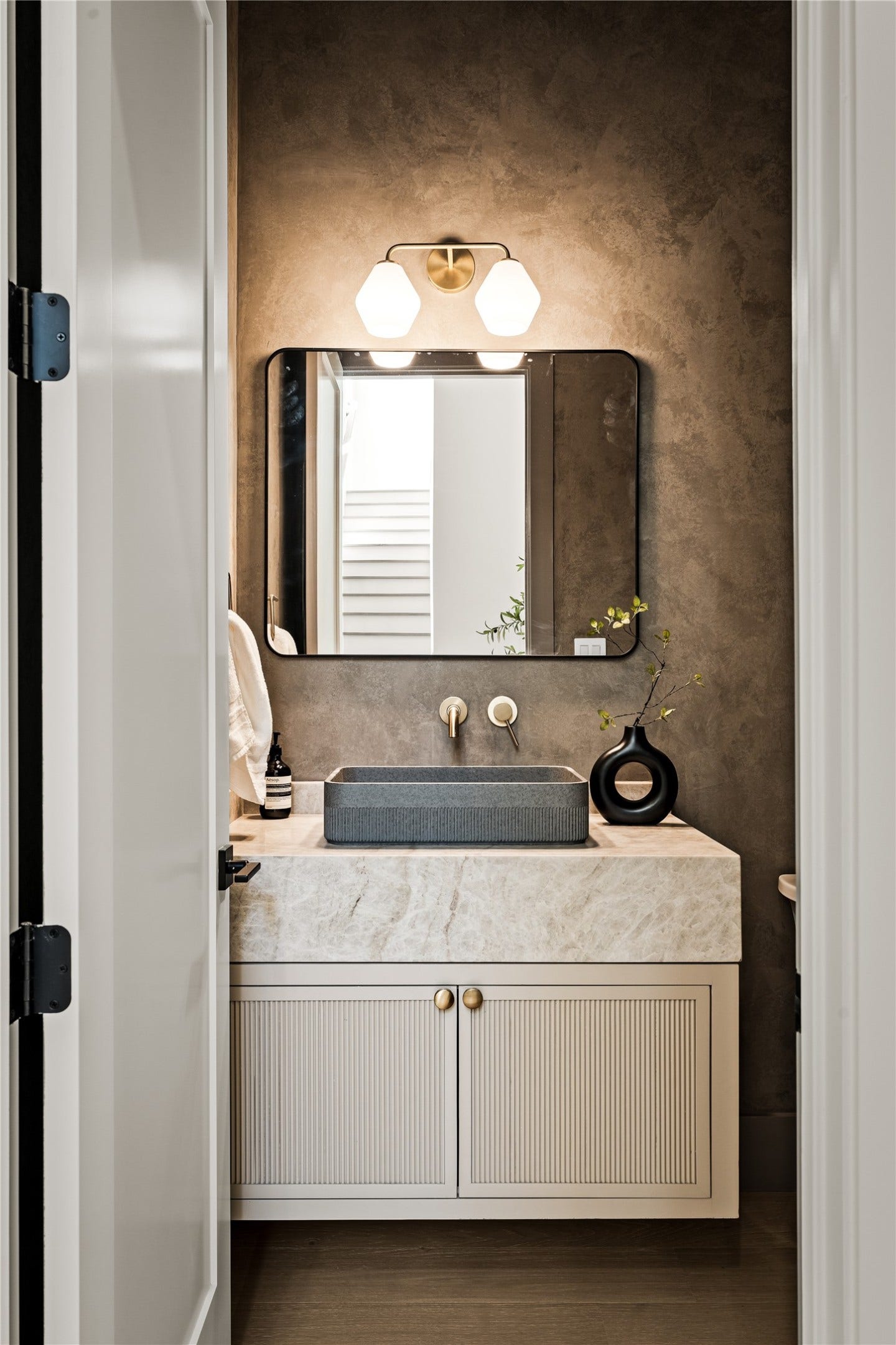 2011 Singleton Street, Houston, TX 77008 Powder bathroom with floating vanity, Taj Mahal apron, and custom Venetian plastering.