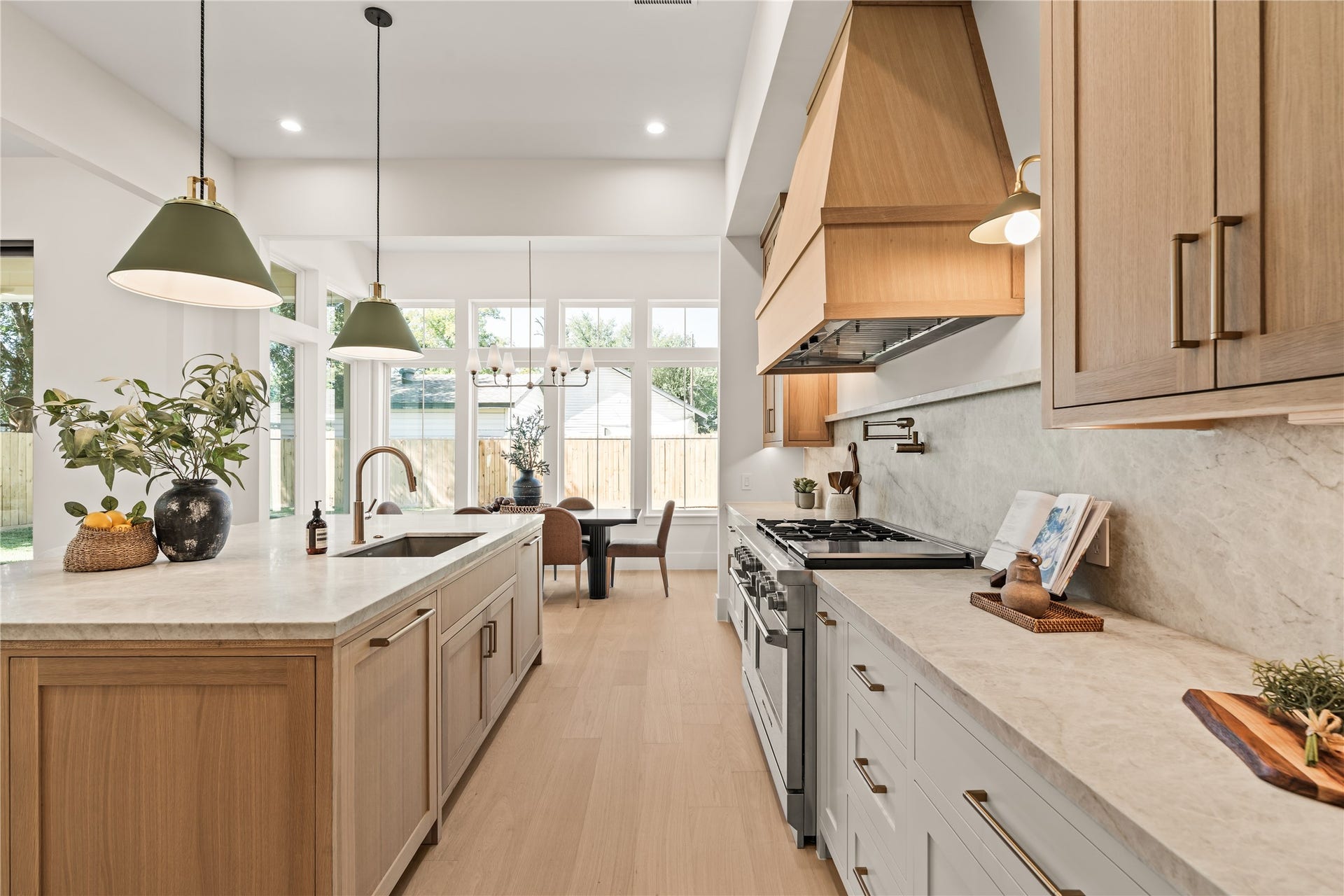 2011 Singleton Street, Houston, TX 77008 Chef's kitchen features a large island with storage cabinets on both sides of the island, top grade Brazilian Taj Mahal Quartzite (natural stone), white oak custom-built inset cabinetry with weighty solid brass champagne bronze pulls, and Fisher & Paykel luxury appliances. The 48" gas range was upgraded to dual fuel (ideal for those who like to bake). Panels hide the 30" column fridge and freezer.