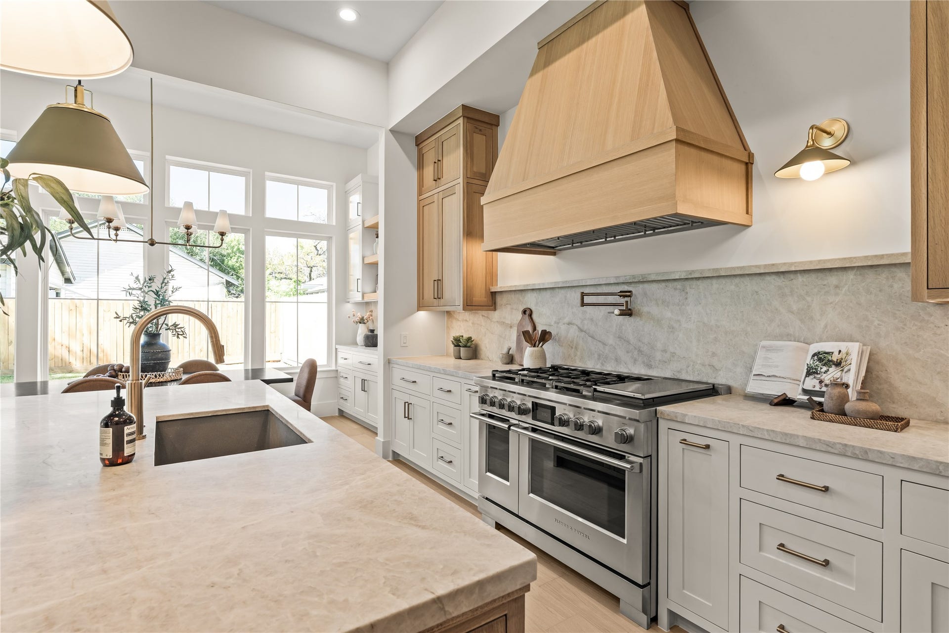2011 Singleton Street, Houston, TX 77008 Chef's kitchen features a large island with storage cabinets on both sides of the island, top grade Brazilian Taj Mahal Quartzite (natural stone), white oak custom-built inset cabinetry with weighty solid brass champagne bronze pulls, and Fisher & Paykel luxury appliances. The 48" gas range was upgraded to dual fuel (ideal for those who like to bake).