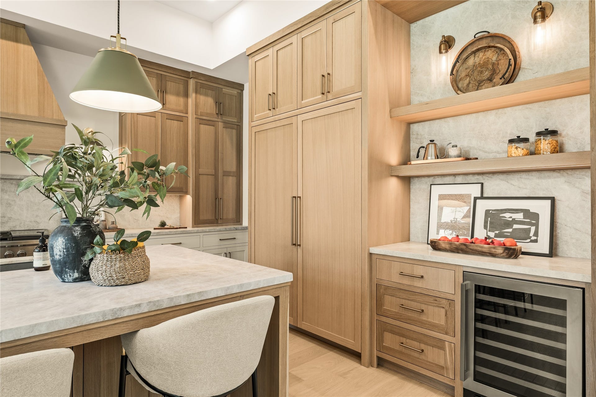 2011 Singleton Street, Houston, TX 77008 Chef's kitchen features a large island with storage cabinets on both sides of the island, top grade Brazilian Taj Mahal Quartzite (natural stone), white oak custom-built inset cabinetry with weighty solid brass champagne bronze pulls, and Fisher & Paykel luxury appliances. The 48" gas range was upgraded to dual fuel (ideal for those who like to bake). Panels hide the 30" column fridge and freezer. Dry bar area complete with wine fridge and white oak shelving to show off your collection of fine spirits.