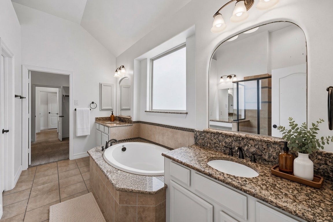 28906 Davenport Drive, Katy, TX 77494 virtually staged - primary bath is stunning with it's symmetry, double vanities, large tub, separate shower, make up nook and access to huge walk in closet