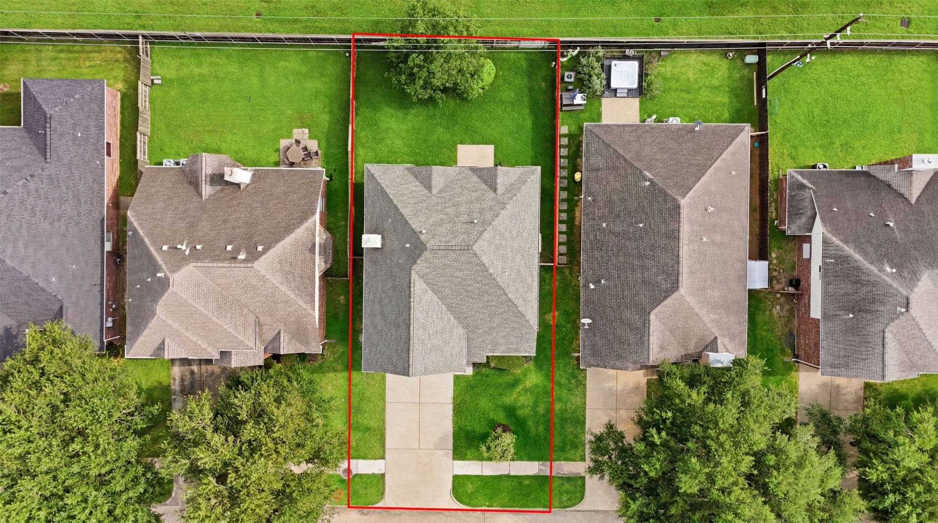 16622 Stoneside Drive, Houston, TX 77095 A direct overhead drone shot outlines the rectangular lot boundaries, property footprint, and front concrete driveway.