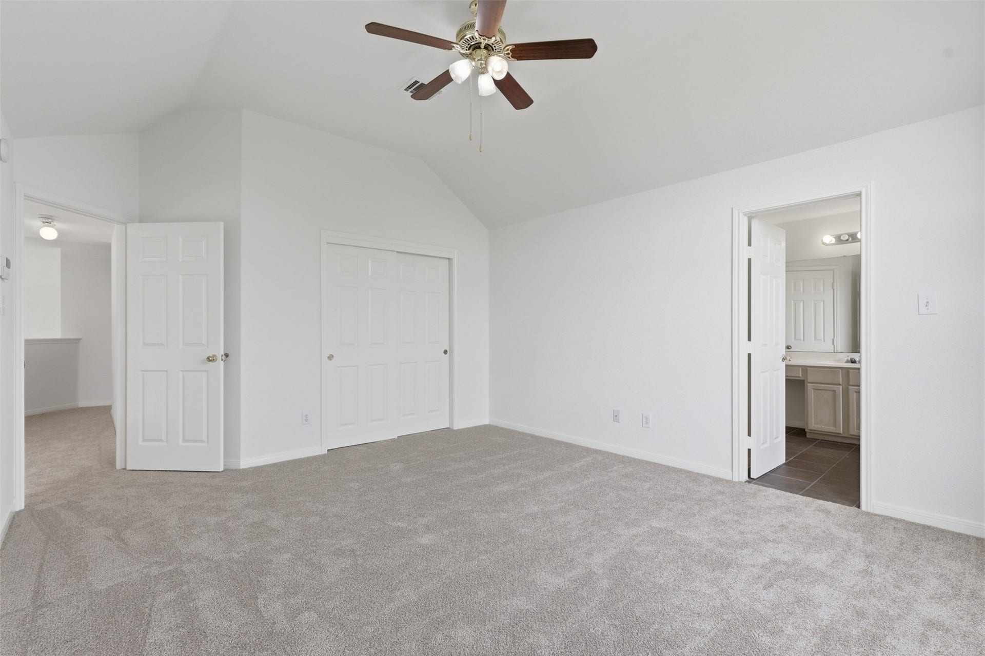 16622 Stoneside Drive, Houston, TX 77095 Alternate view of the primary bedroom which features multi-panel doors, a sliding closet, and a direct entrance to an en suite bathroom.