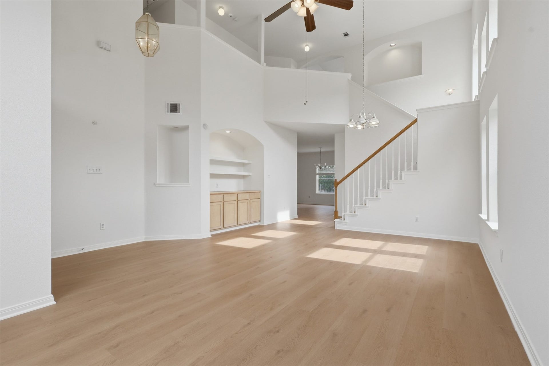 16622 Stoneside Drive, Houston, TX 77095 Custom base cabinetry and exposed shelving integrate seamlessly into a smooth alcove above the pale plank flooring.