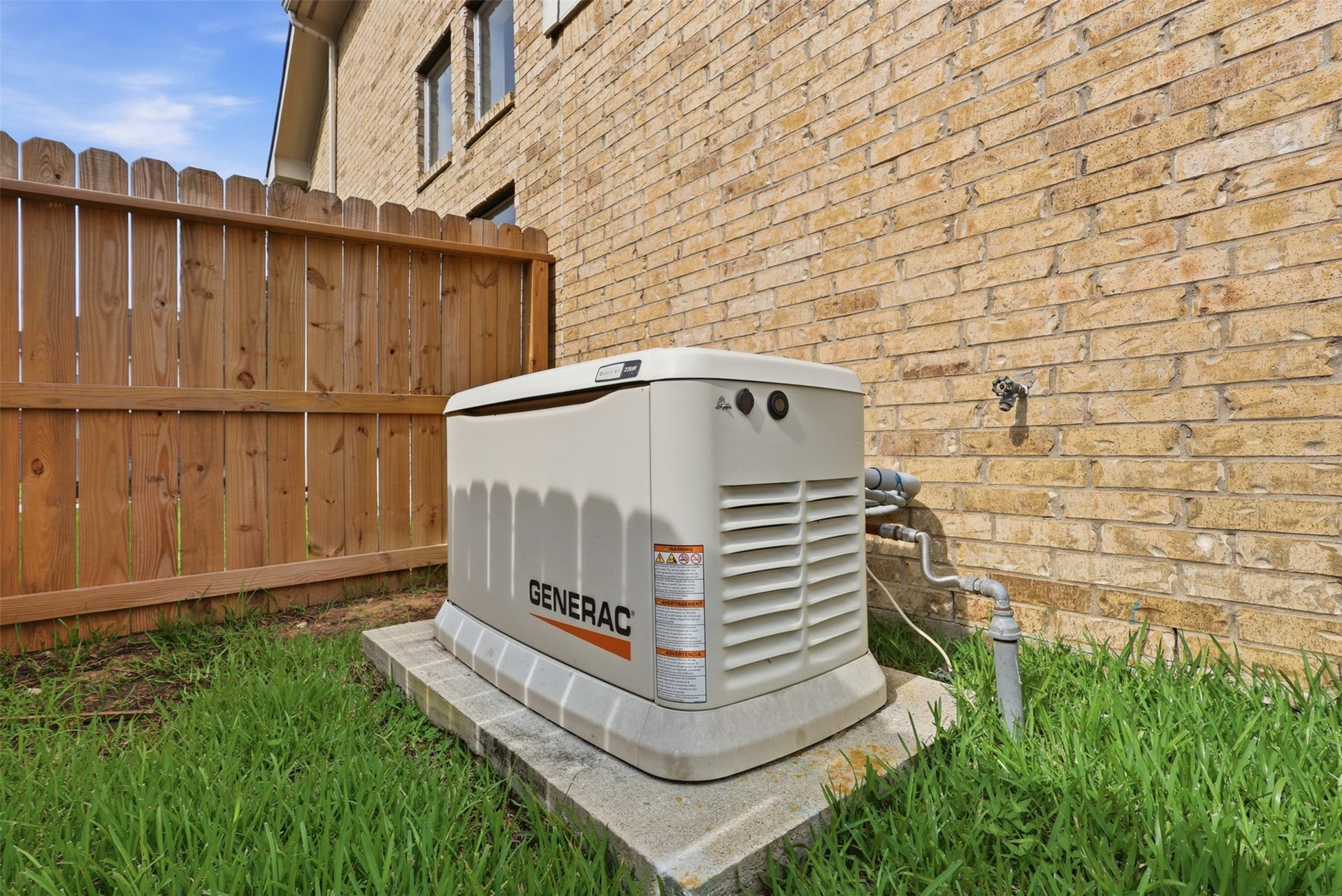 16622 Stoneside Drive, Houston, TX 77095 A heavy-duty backup power generator sits safely mounted on a concrete slab adjacent to the exterior brick masonry.