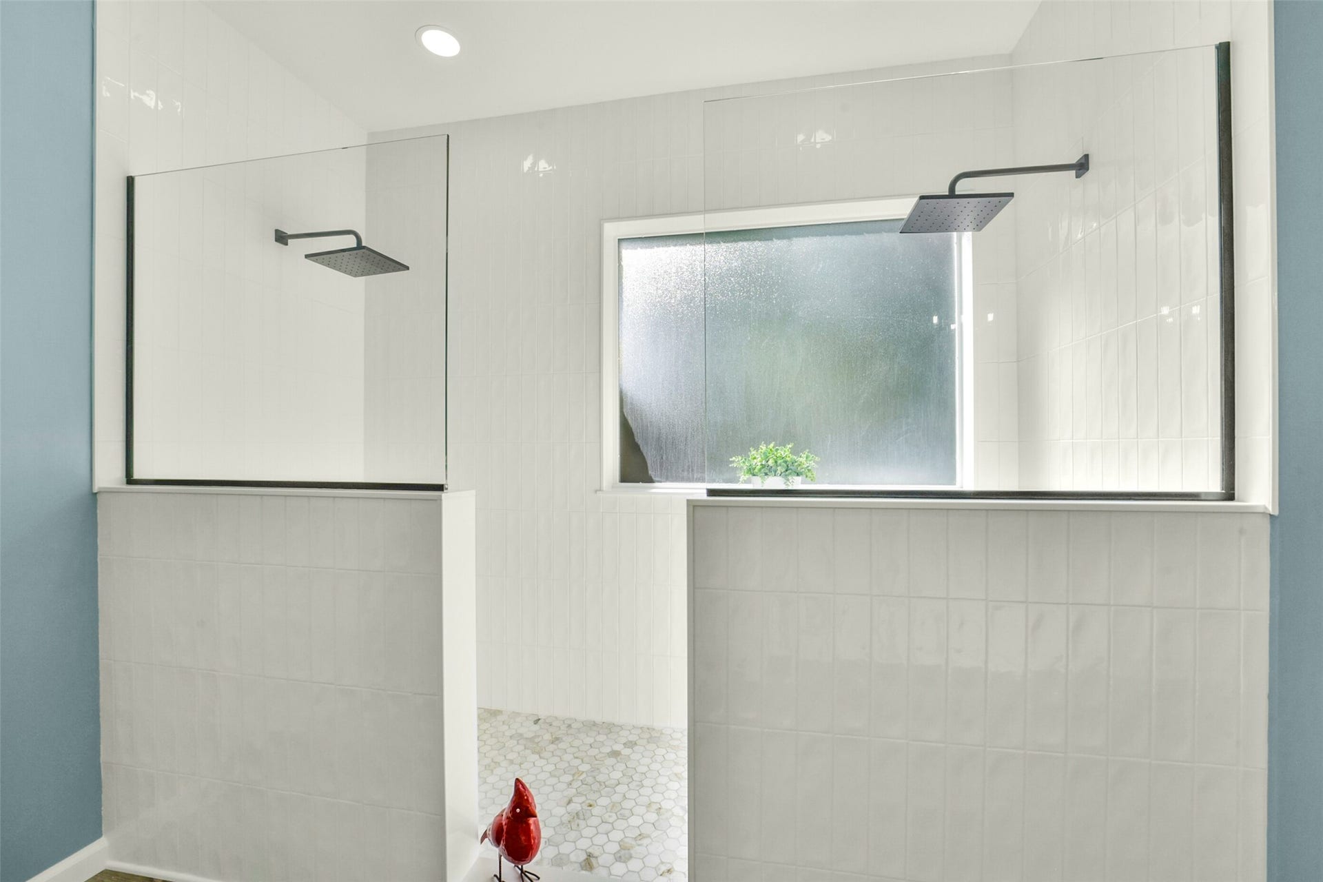15730 Lake Loop Drive, Cypress, TX 77433 Sleek, modern shower with dual rainfall heads, frosted window, and elegant tilework for a spa-like experience.