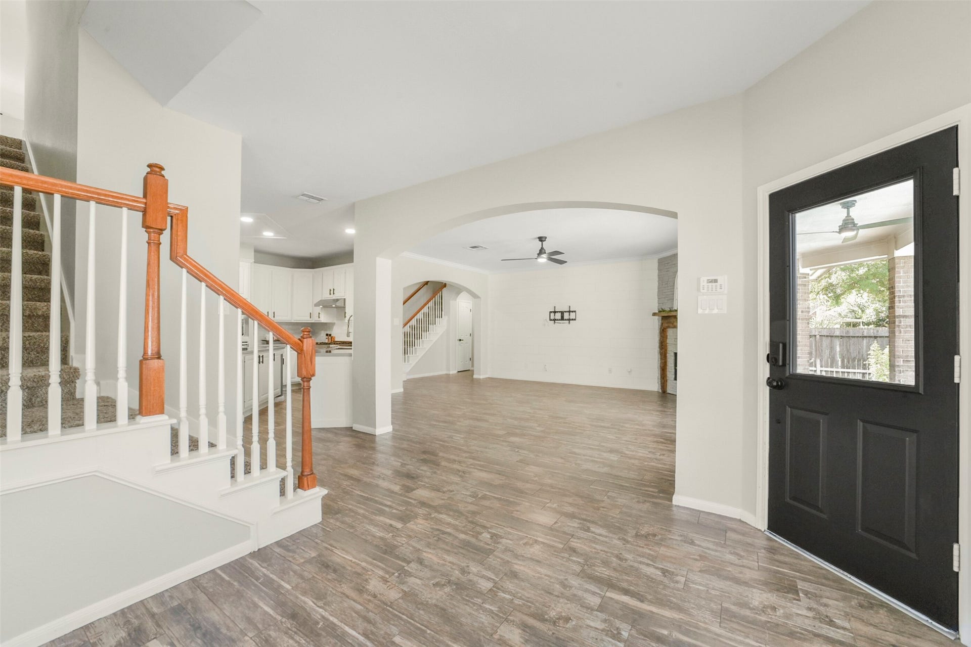 15730 Lake Loop Drive, Cypress, TX 77433 Spacious open-concept living area, seamlessly connects to a stylish kitchen with a breakfast bar. this layout offers easy access to both the upstairs and a welcoming entryway.