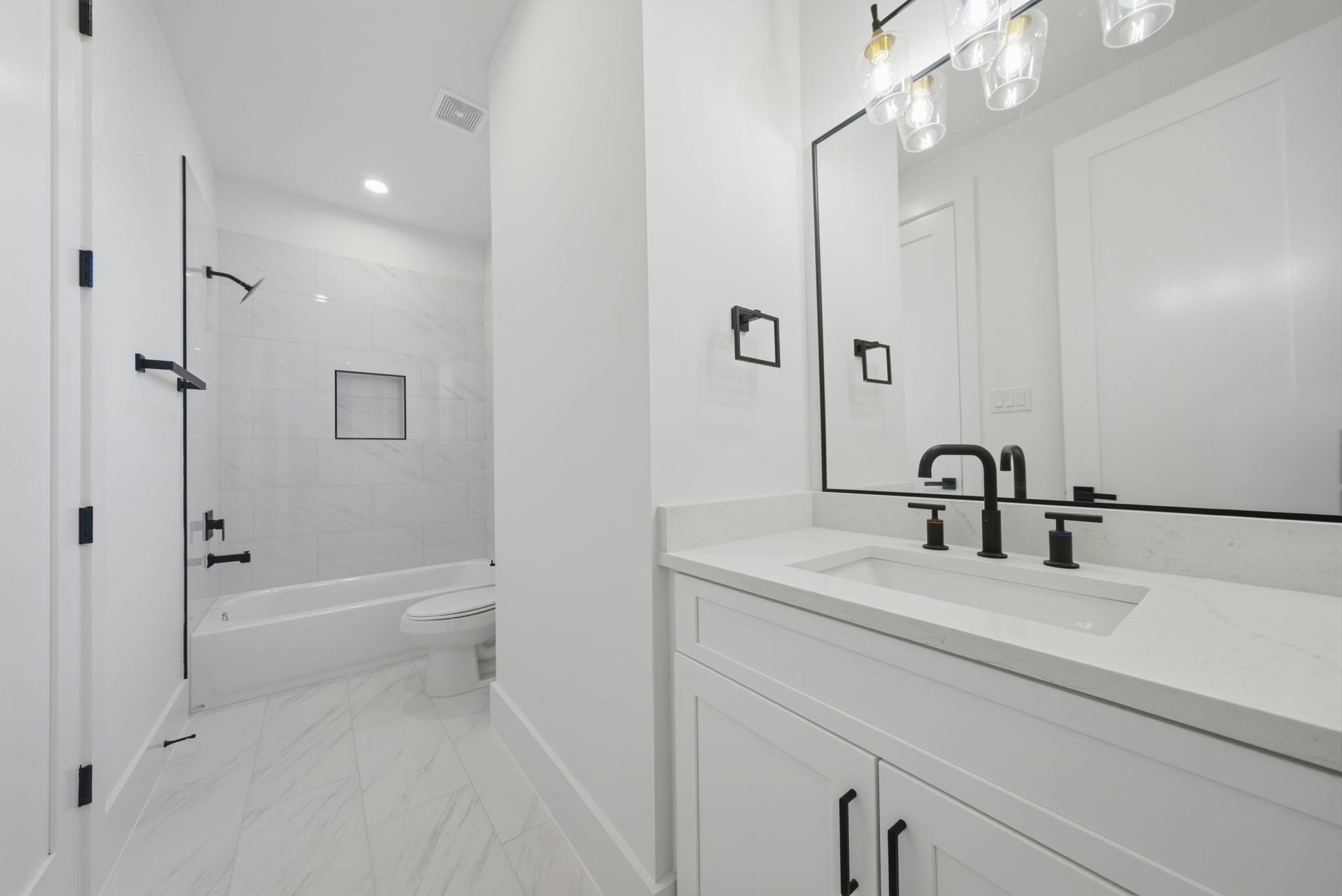Guest bath #2 with quartz counters, black matte hardware, and plenty of storage and counter space. (Photos are of a previously completed home. Finishes are subject to change.)