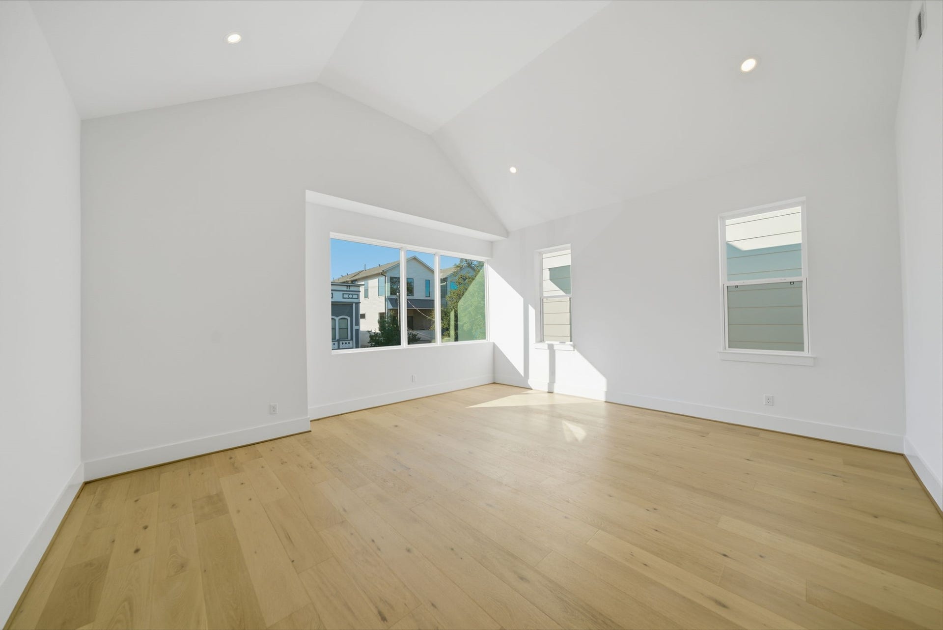 Impressive primary bedroom features a unique cathedral ceiling and amazing oversized windows. (Photos are of a previously completed home. Finishes are subject to change.)