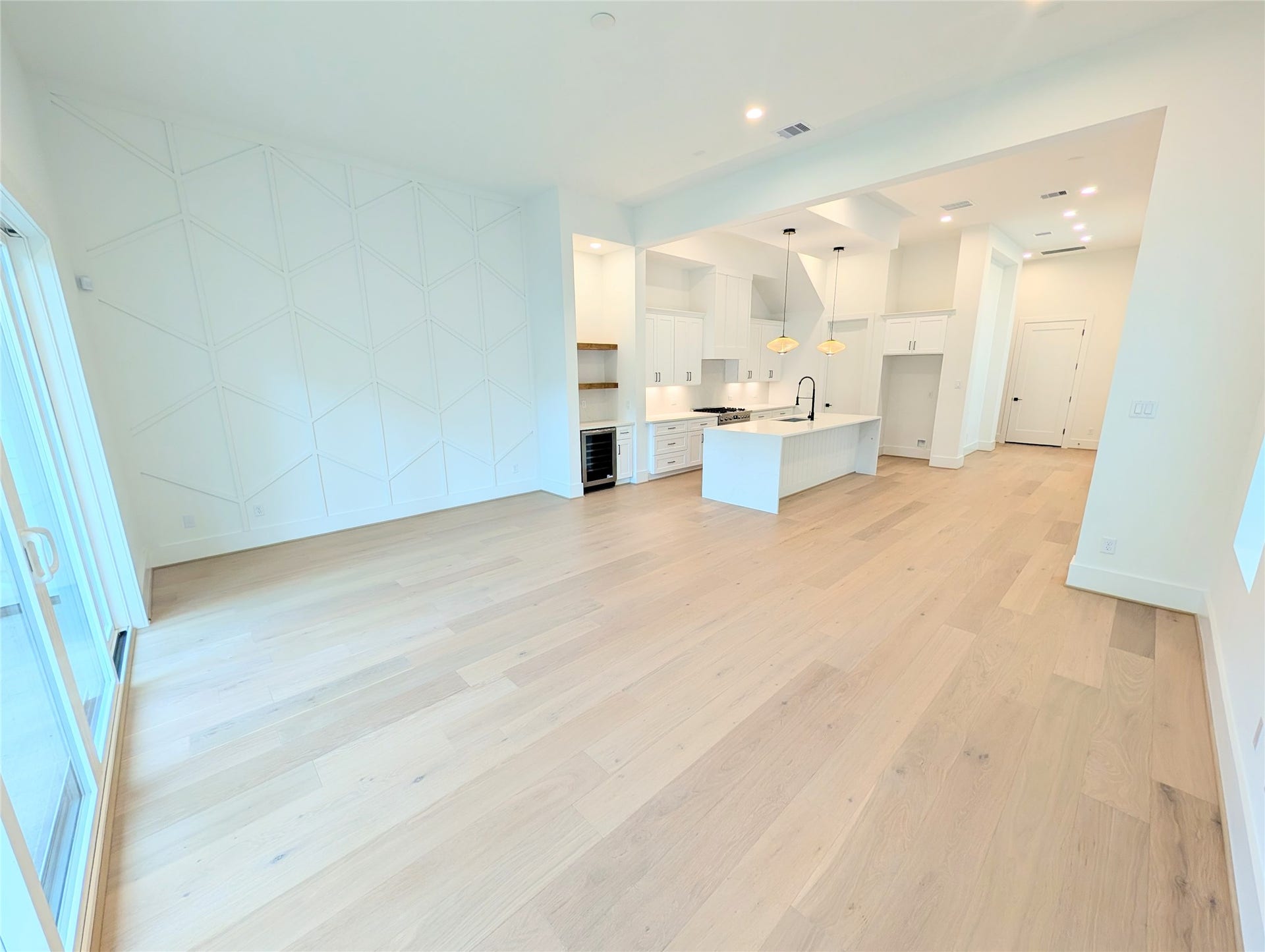 Highlighting the modern living concept, this open floor plan with 13 foot ceilings and windows. Living room open to the dining area and chef's kitchen