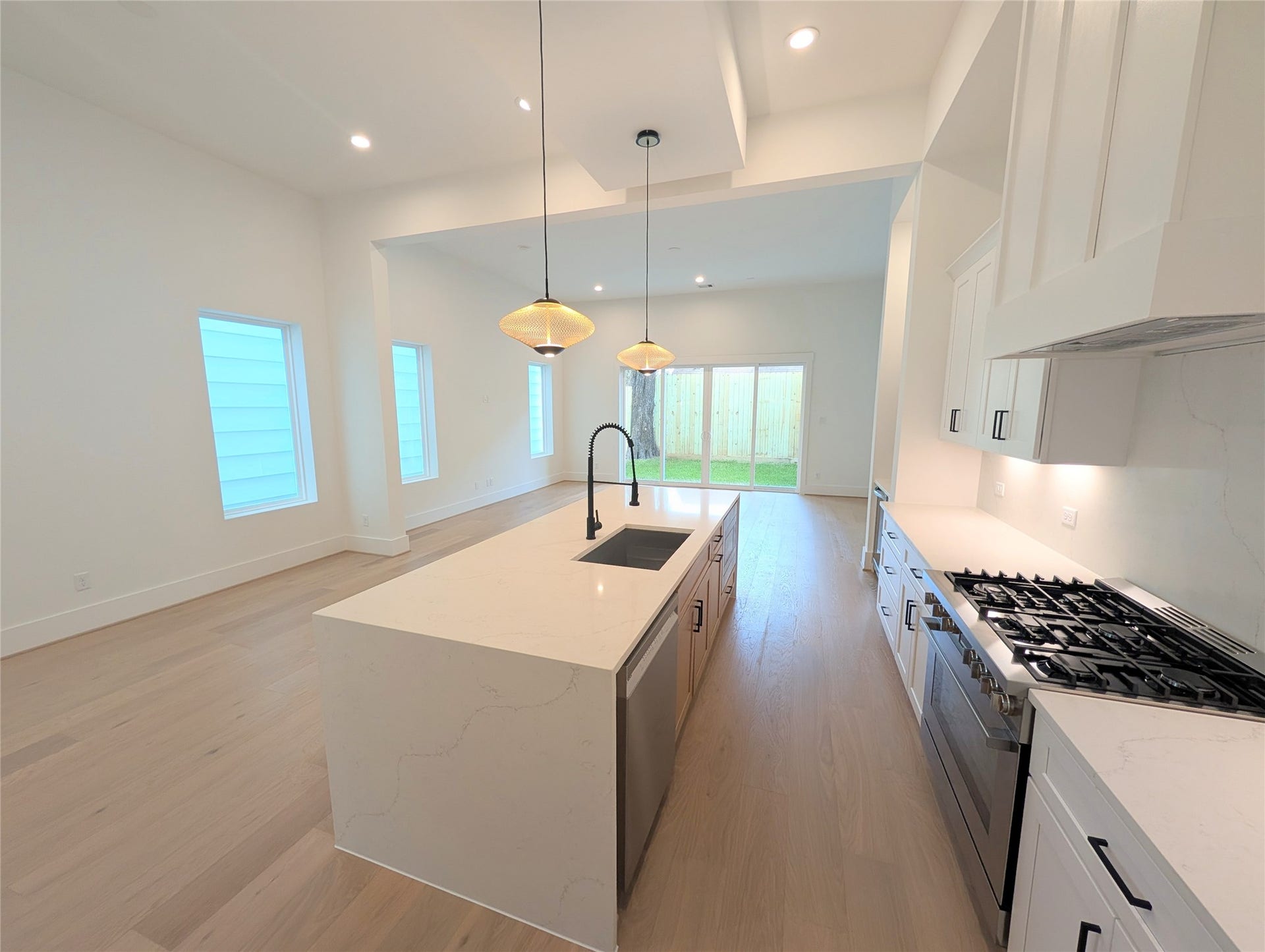 Chef's kitchen with modern open feel highlighted by Bosch appliance package all around.