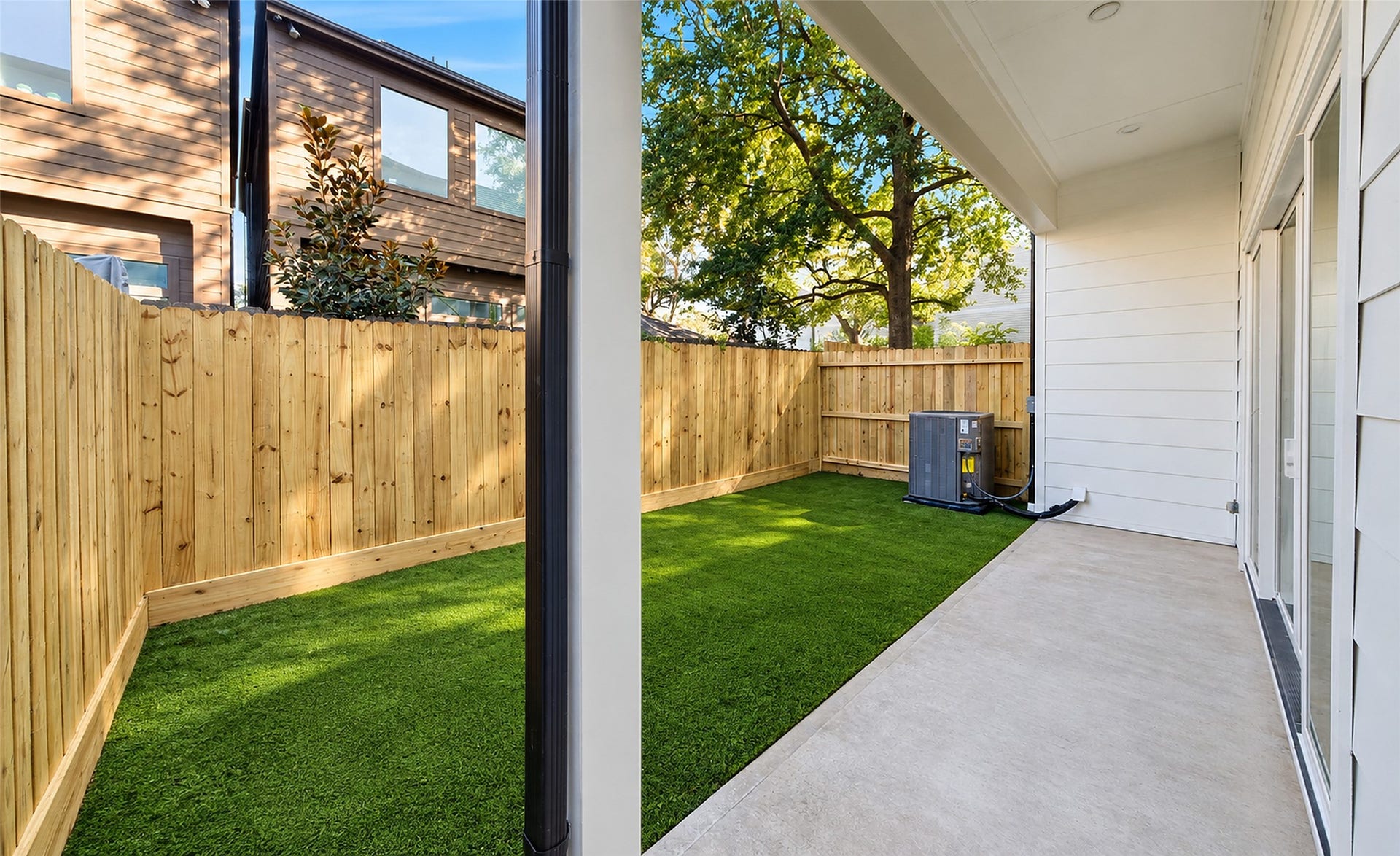 Covered patio ready for outdoor kitchen with gas access and furniture area.