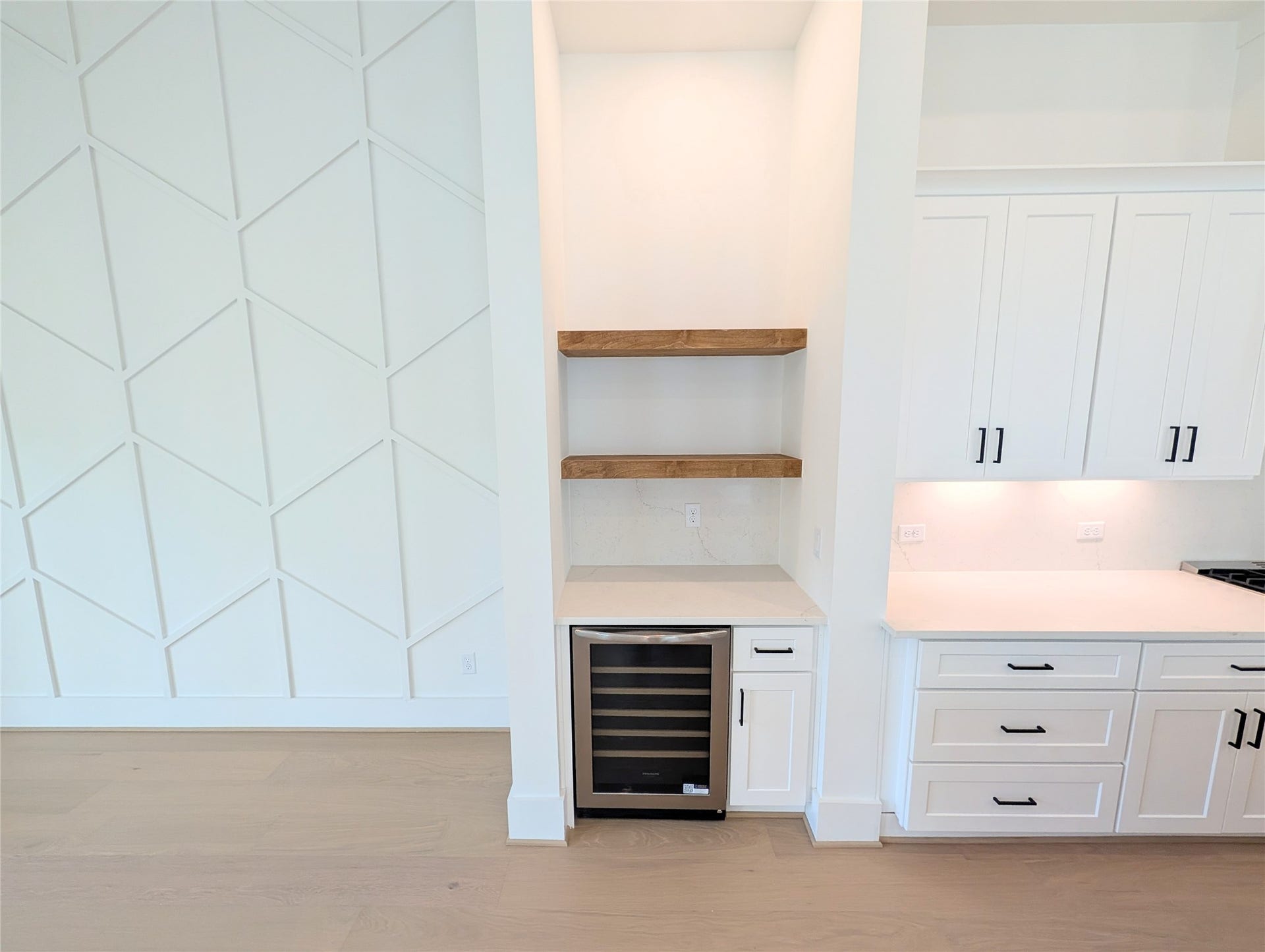 Dry bar and wine fridge are perfectly situated between the living and kitchen areas.  Perfect for entertaining!