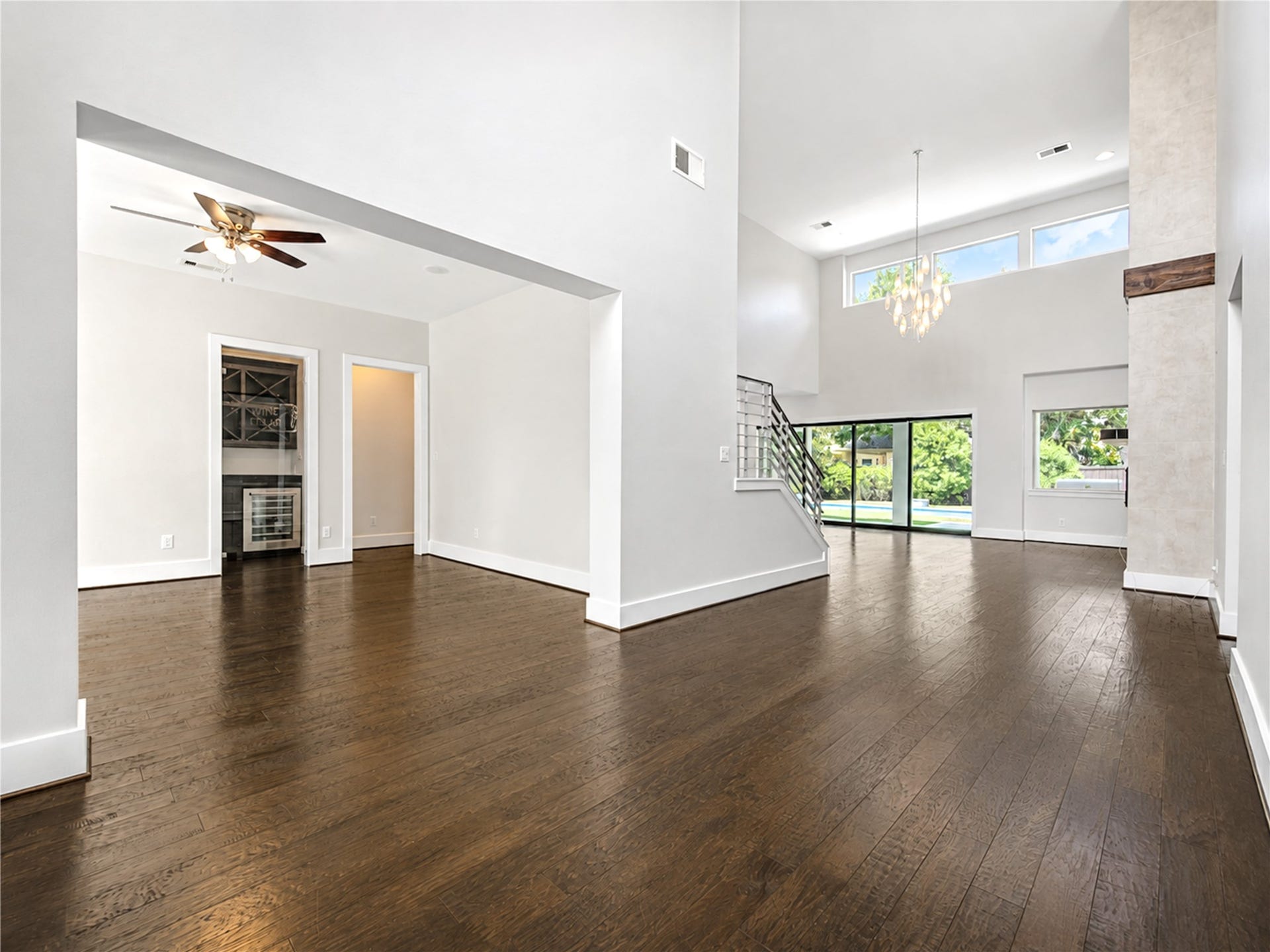 Step inside to freshly painted interiors, soaring two-story ceilings and rich wood floors. The formal dining room features a built-in wine bar with bottle storage and wine refrigerator.