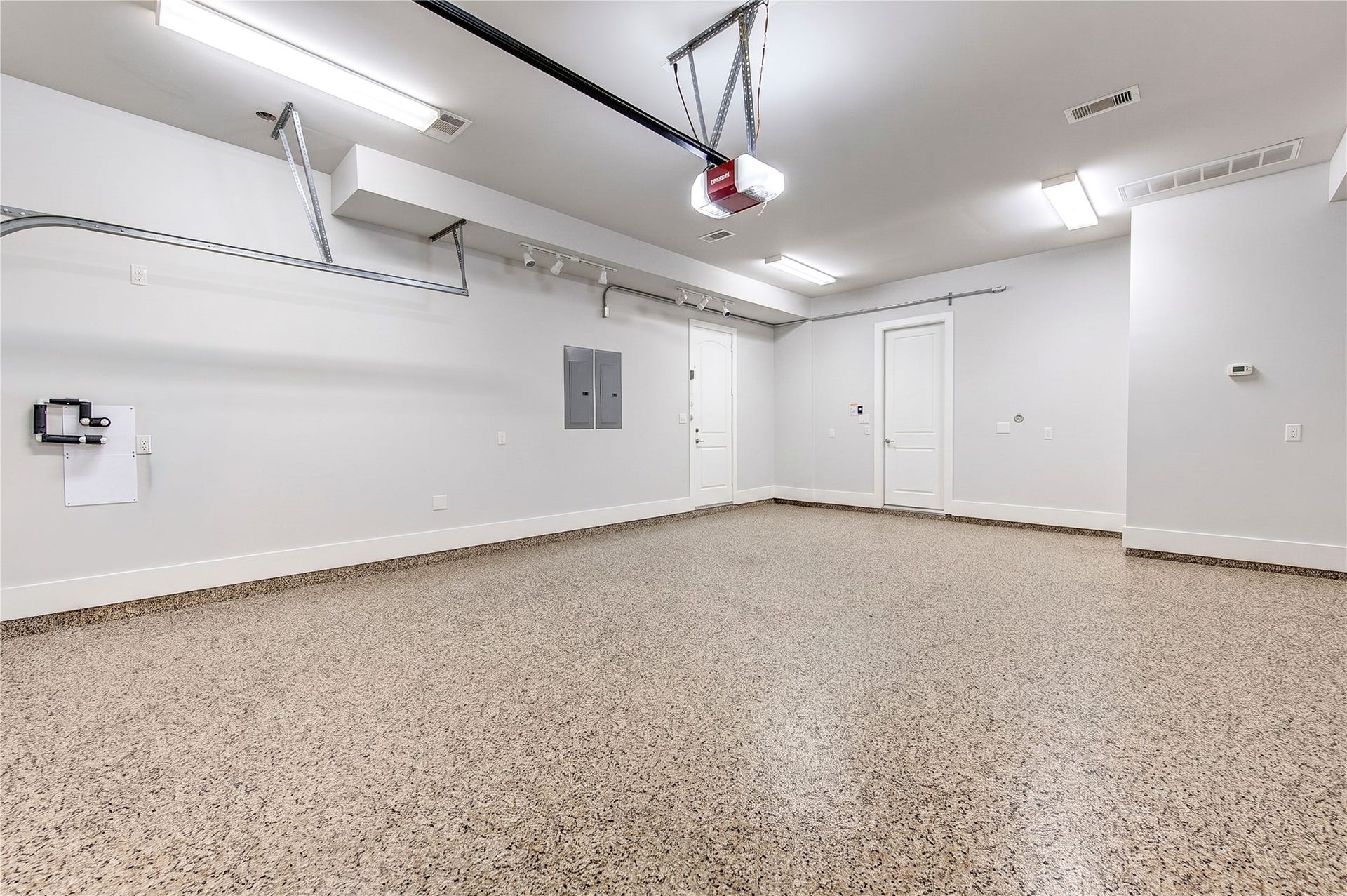 The climate-controlled two-car garage is thoughtfully pre-wired for future EV charging and pre-plumbed for future water-softener installation.