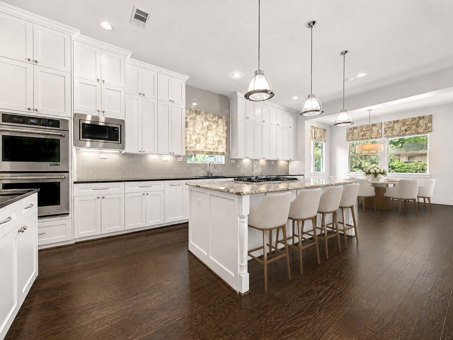 A dream for the home chef and entertainer, the kitchen offers double ovens, a gas cooktop, abundant storage and a spacious island with ample seating. Digitally staged.