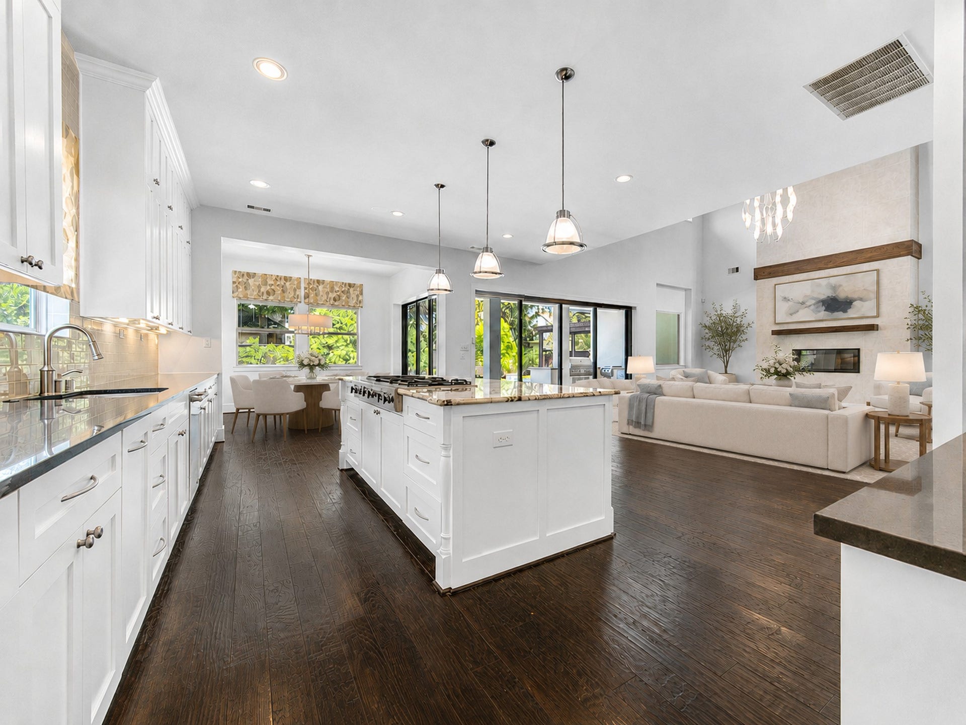 Designed for gathering, the chef's kitchen features an oversized island, abundant cabinetry and effortless flow into the breakfast room, great room and outdoors. Digitally staged.