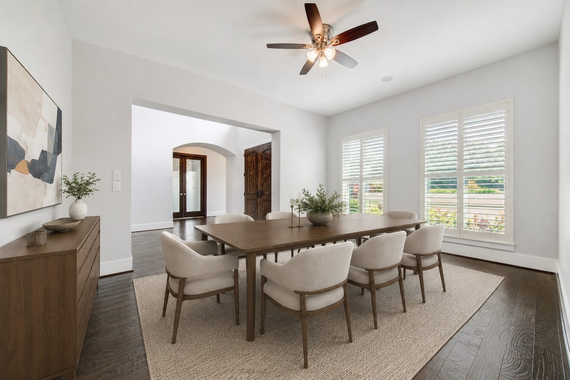 Filled with natural light and tranquil lake views, the expansive formal dining room creates an elegant setting for intimate dinners and special occasions. Digitally staged.