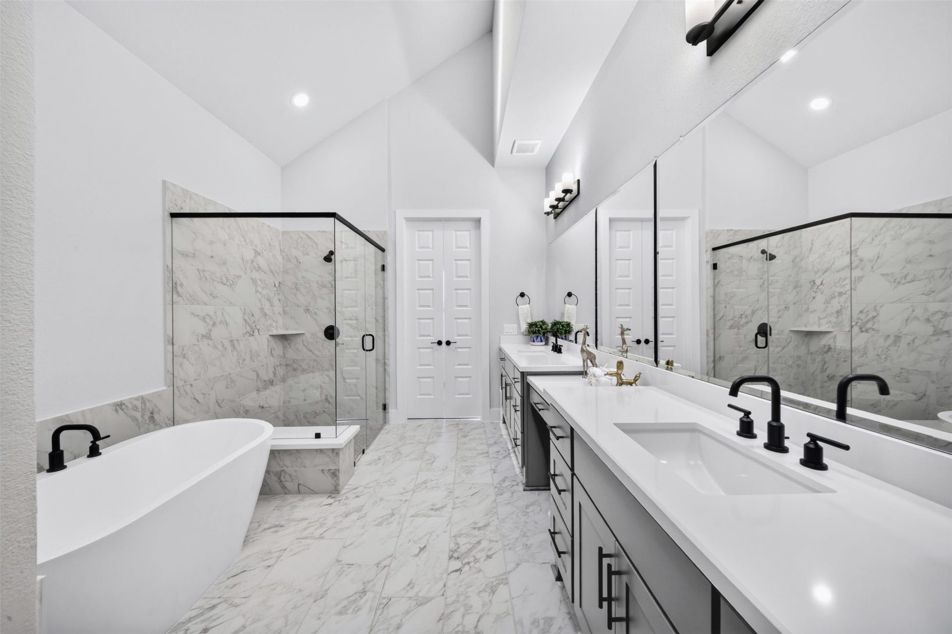 32510 Ebony Jewelwing Court, Fulshear, TX 77441 Primary Bathroom: Another impressive view highlighting the spacious layout, dual vanity areas, freestanding tub, oversized shower, and soaring ceiling.