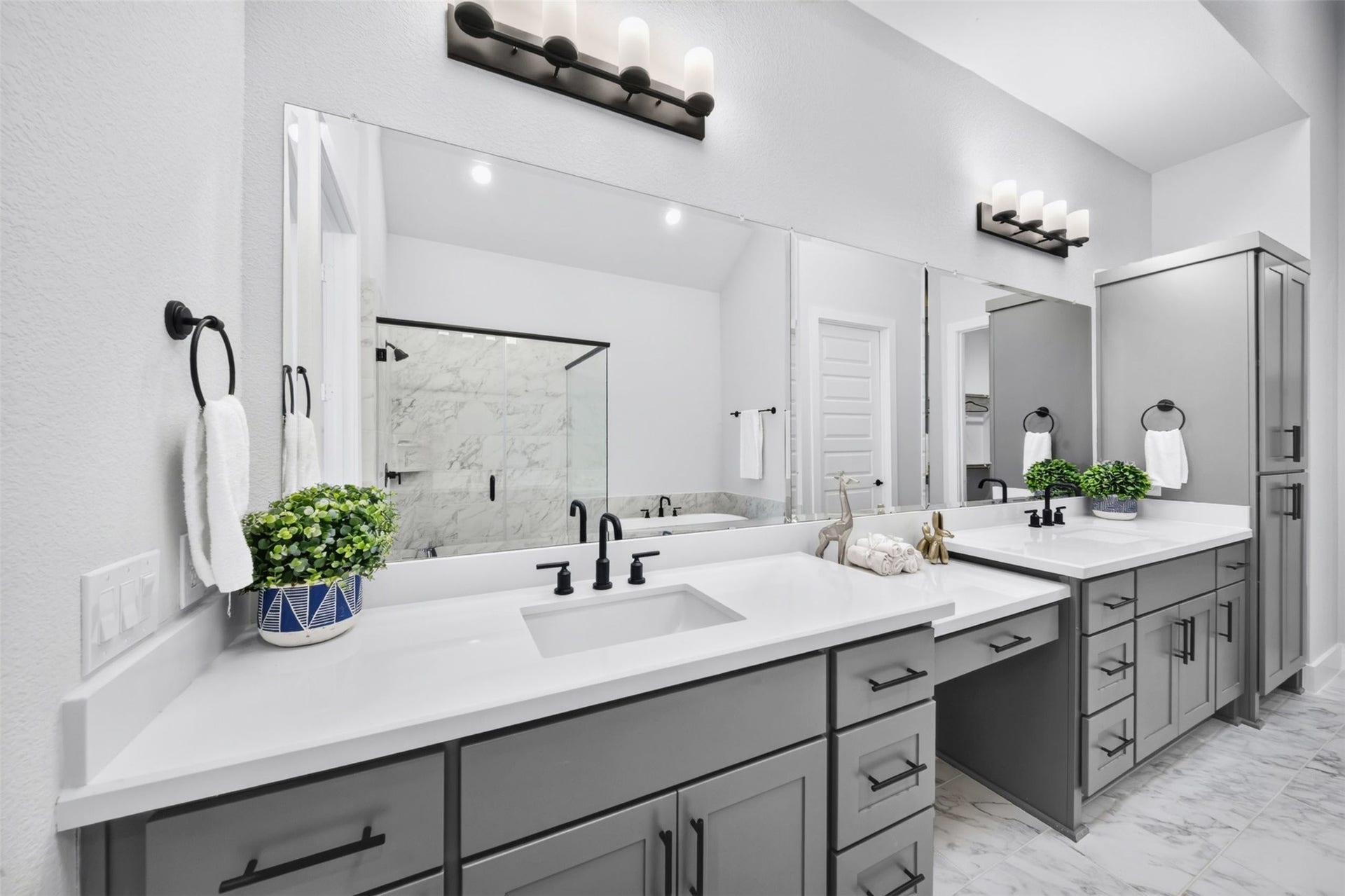 32510 Ebony Jewelwing Court, Fulshear, TX 77441 Primary Bathroom Impressive primary bath with expansive dual vanities, abundant cabinetry, oversized mirrors, contemporary fixtures, and a beautifully tiled shower.