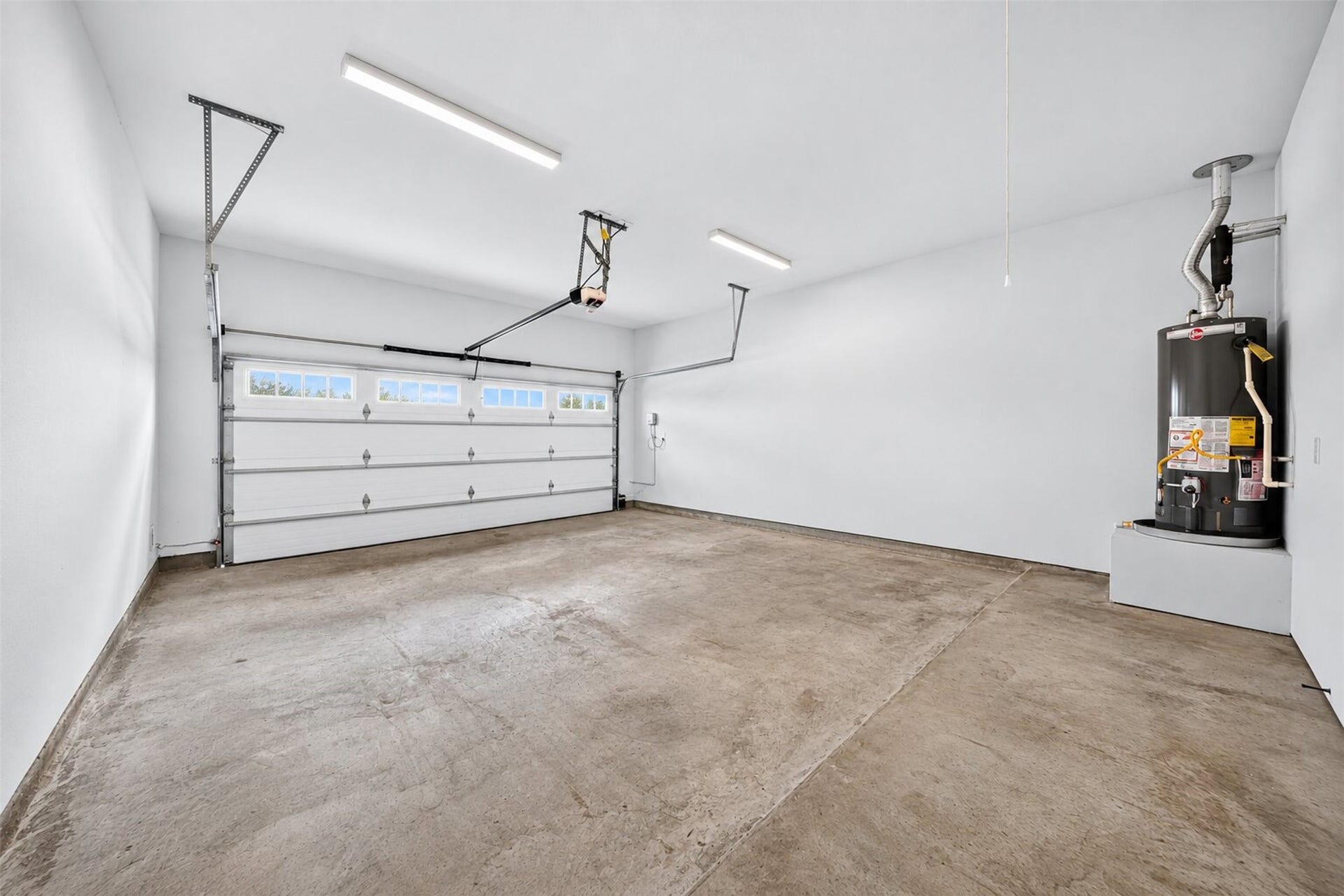 32510 Ebony Jewelwing Court, Fulshear, TX 77441 Garage Spacious garage with bright overhead lighting and ample room for parking and additional storage.