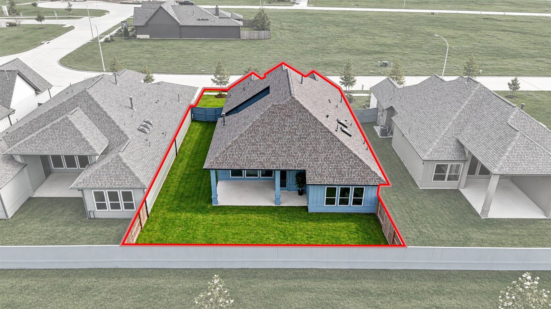 32510 Ebony Jewelwing Court, Fulshear, TX 77441 Property Aerial: Aerial perspective highlights the home's lot, fenced backyard, covered outdoor living area, and placement within the community.
