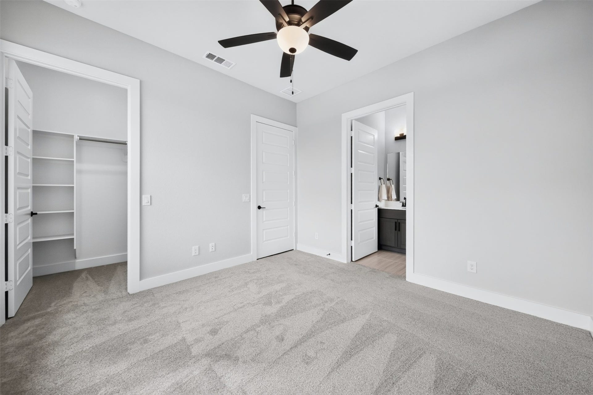 32510 Ebony Jewelwing Court, Fulshear, TX 77441 Secondary Bedroom Spacious secondary bedroom with high ceiling, ceiling fan, generous closet space, and convenient access to a full bath.