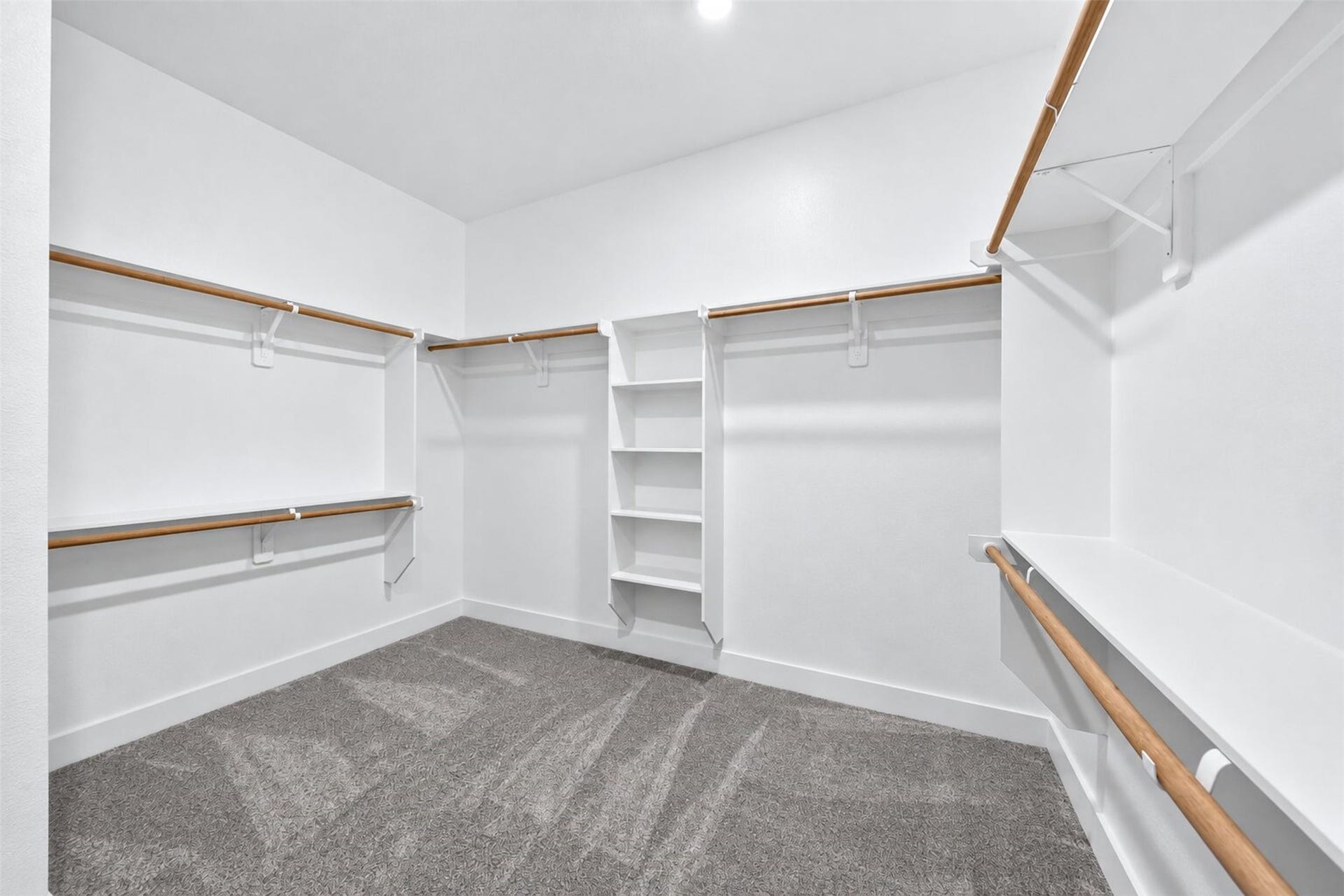 32510 Ebony Jewelwing Court, Fulshear, TX 77441 Primary Walk-In Closet Expansive walk-in closet with abundant hanging space, built-in shelving, and a thoughtfully designed storage layout.