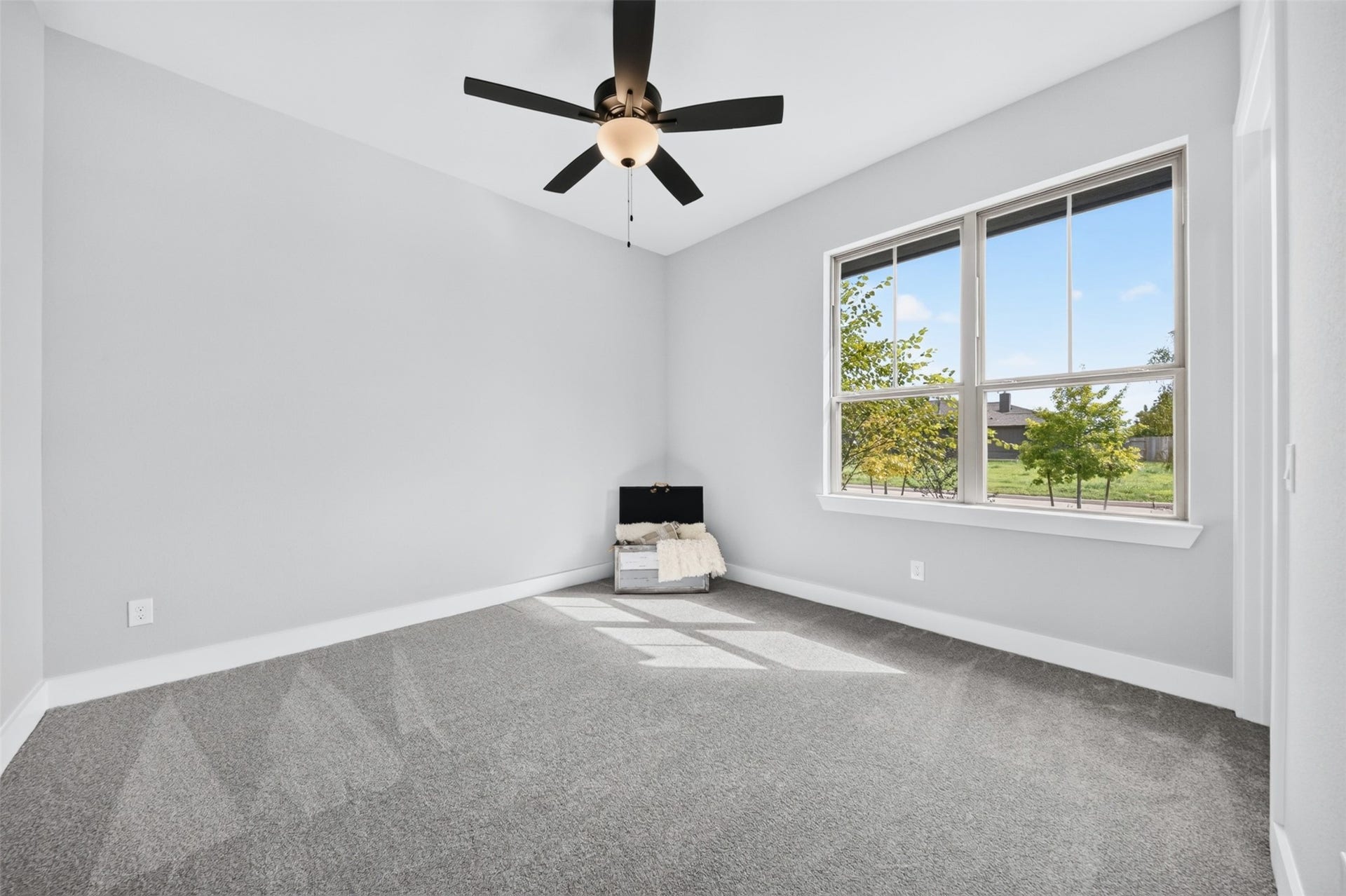32510 Ebony Jewelwing Court, Fulshear, TX 77441 Secondary Bedroom Light-filled secondary bedroom with neutral finishes, plush carpeting, ceiling fan, and a large window bringing in abundant natural light.