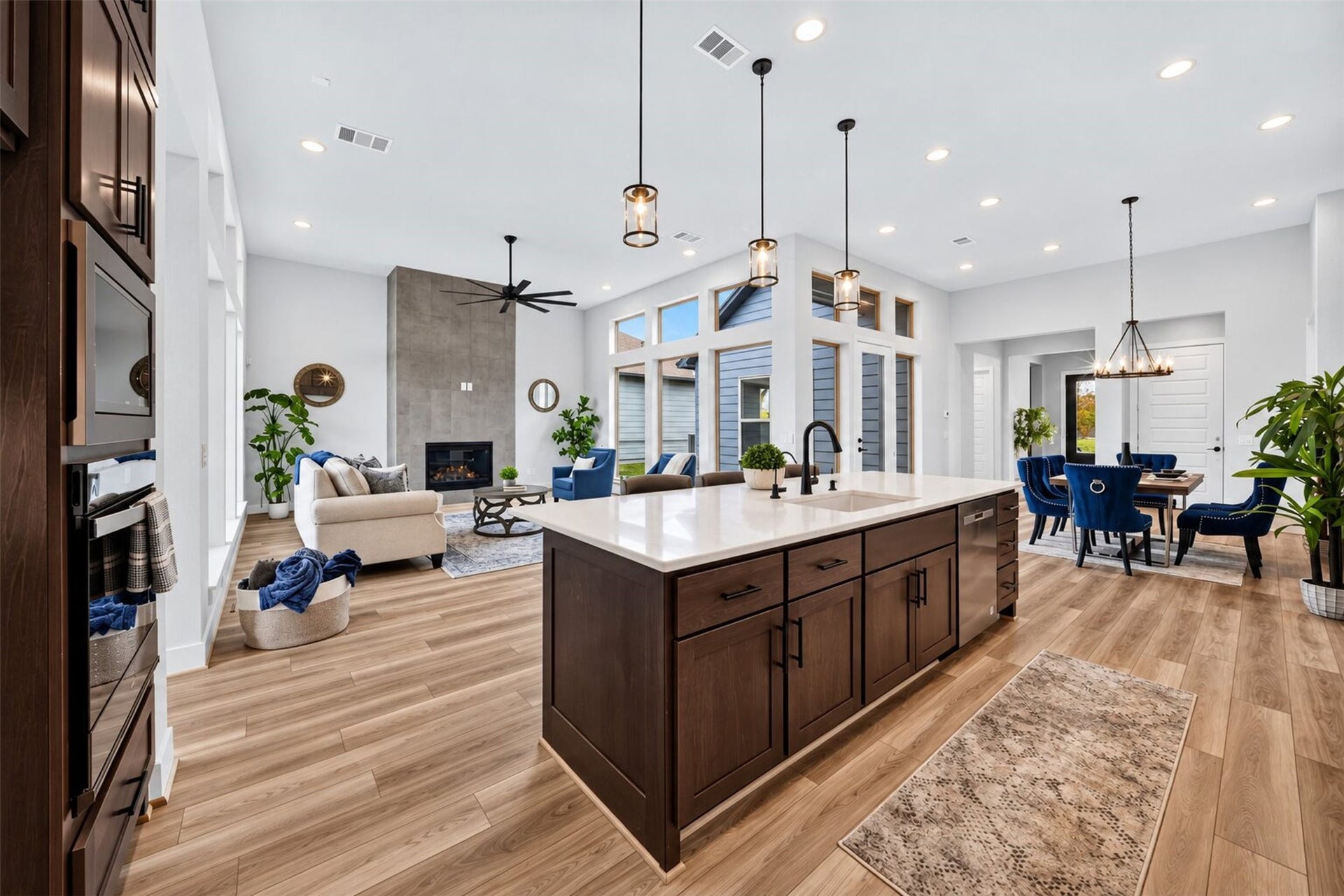 32510 Ebony Jewelwing Court, Fulshear, TX 77441 Kitchen & Living: Expansive kitchen island anchors the open-concept design with clear sightlines to the dining and living areasideal for everyday living and entertaining.