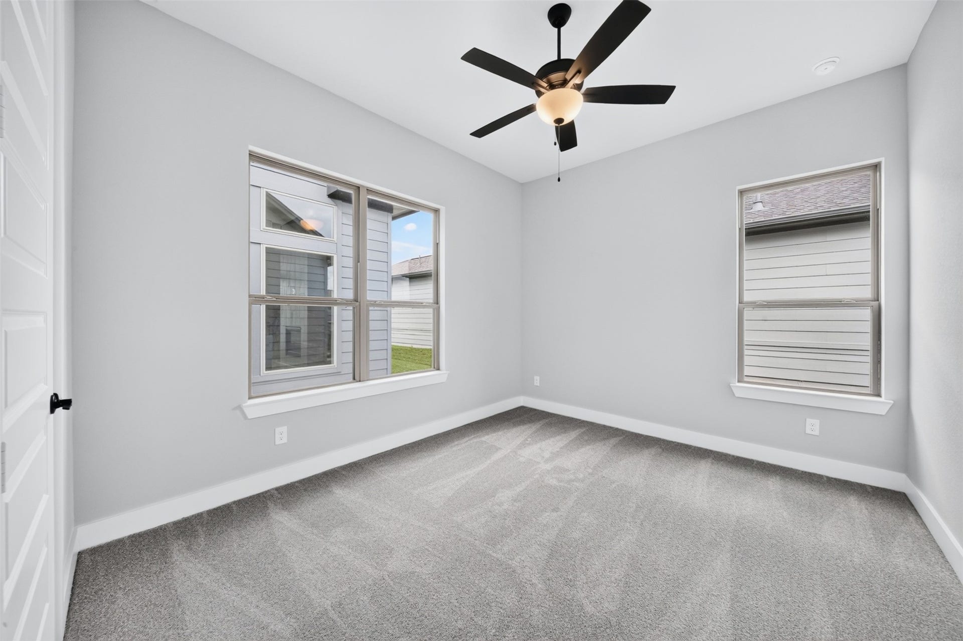 32510 Ebony Jewelwing Court, Fulshear, TX 77441 Secondary Bedroom Inviting secondary bedroom surrounded by multiple windows, creating a bright and airy atmosphere with plenty of natural light.