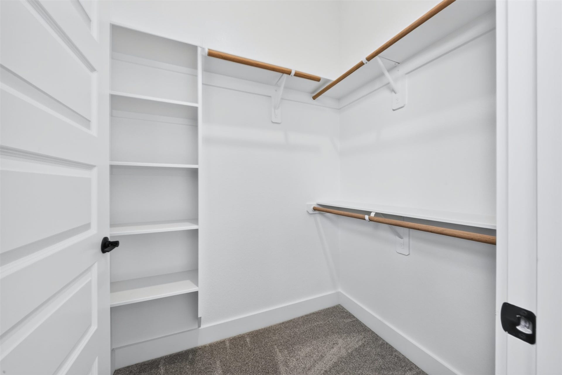 32510 Ebony Jewelwing Court, Fulshear, TX 77441 Walk-In Closet Well-designed walk-in closet offering built-in shelving and multiple hanging areas for organized storage.