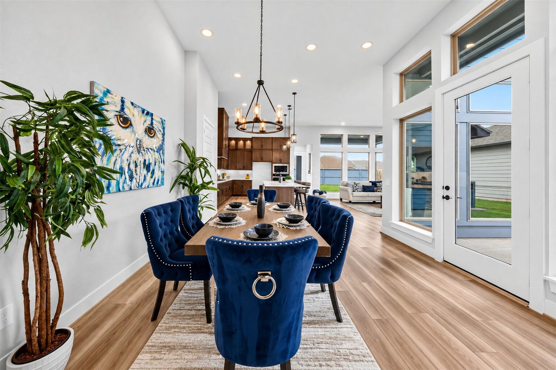 32510 Ebony Jewelwing Court, Fulshear, TX 77441 Dining Area: Elegant dining space surrounded by oversized windows and a glass door, creating a bright connection between the interior and outdoor spaces.