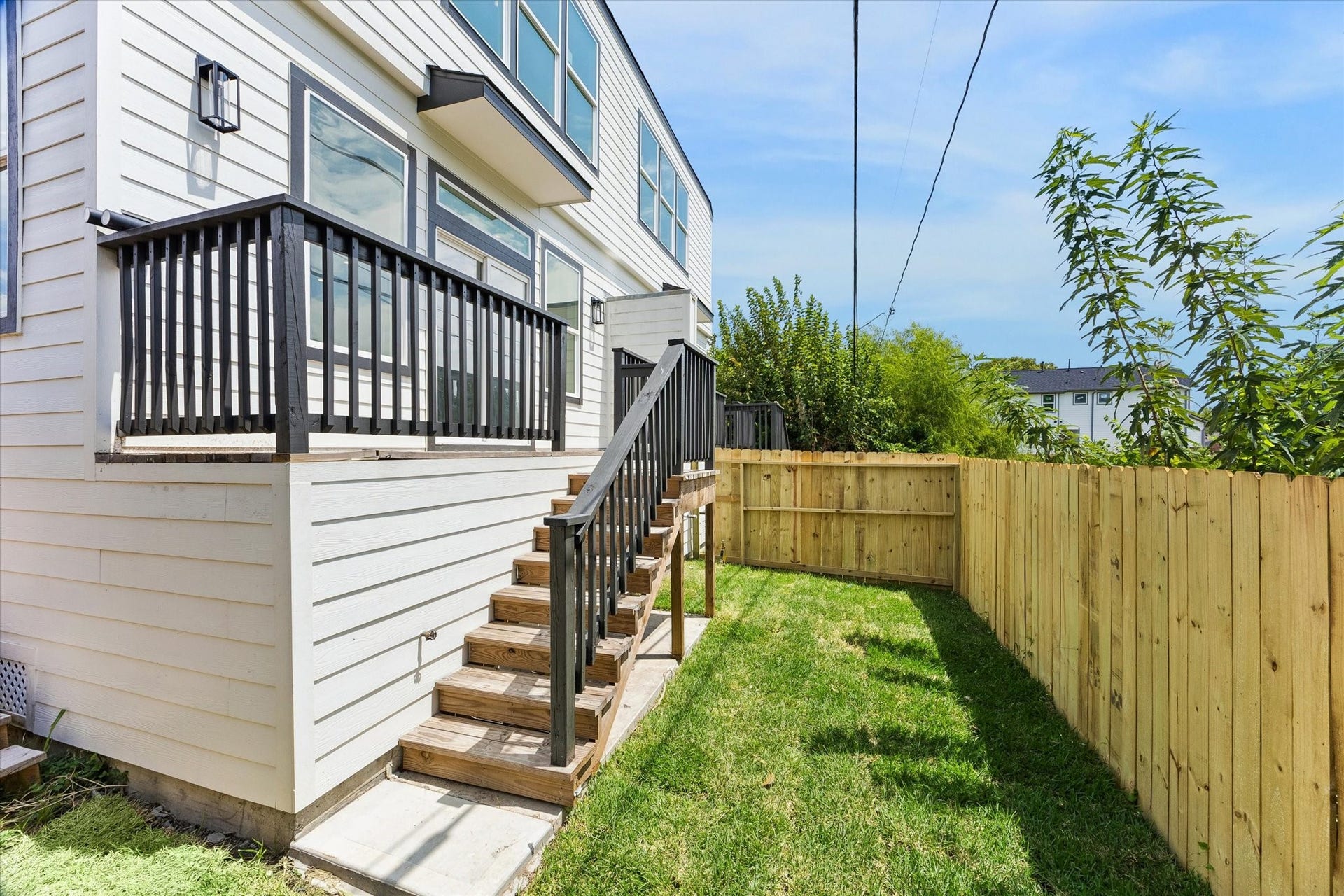 5106 Ricky Street, #A, Houston, TX 77033 Each unit offers a private fenced area and balcony with stairs leading down.
