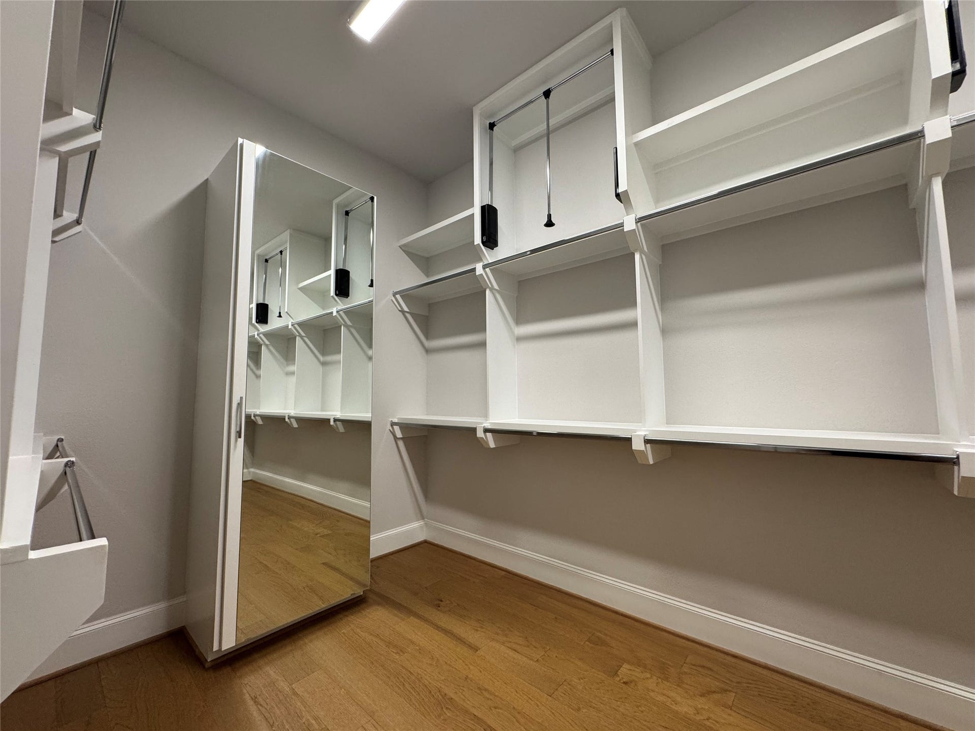 11053 Chatterton Drive, Houston, TX 77043 Primary closet (1 of 2) is the size of a bedroom! Note the pull-down rods and full length mirror on door to chest of drawers!