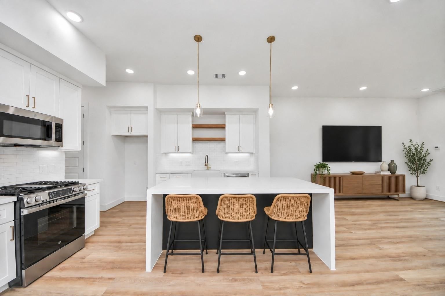 2606 Winbern Street, Houston, TX 77004 Virtually staged open-concept kitchen with spacious kitchen island and stainless steel appliances.